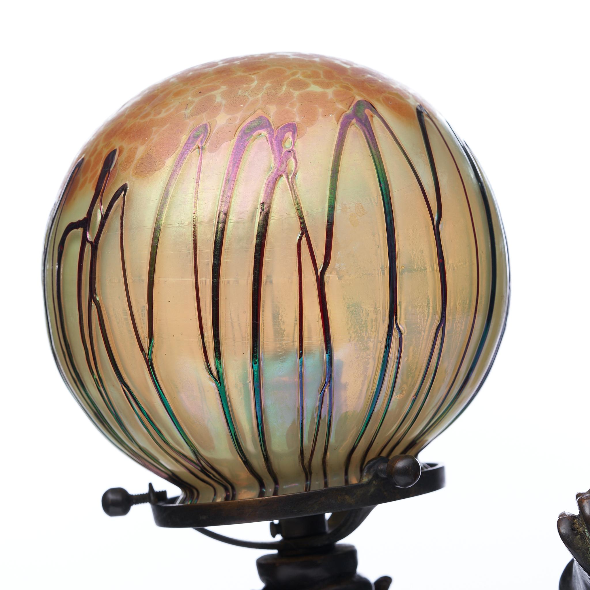 Pair of Durand, circa 1930's bronze lamps (attributed). No makers marks found.

The Loetz- style art glass globes are typical of the work of Martin Bach Jr. Each of the shades is supported by a rearing bronze pegasus winged horse. We came across a
