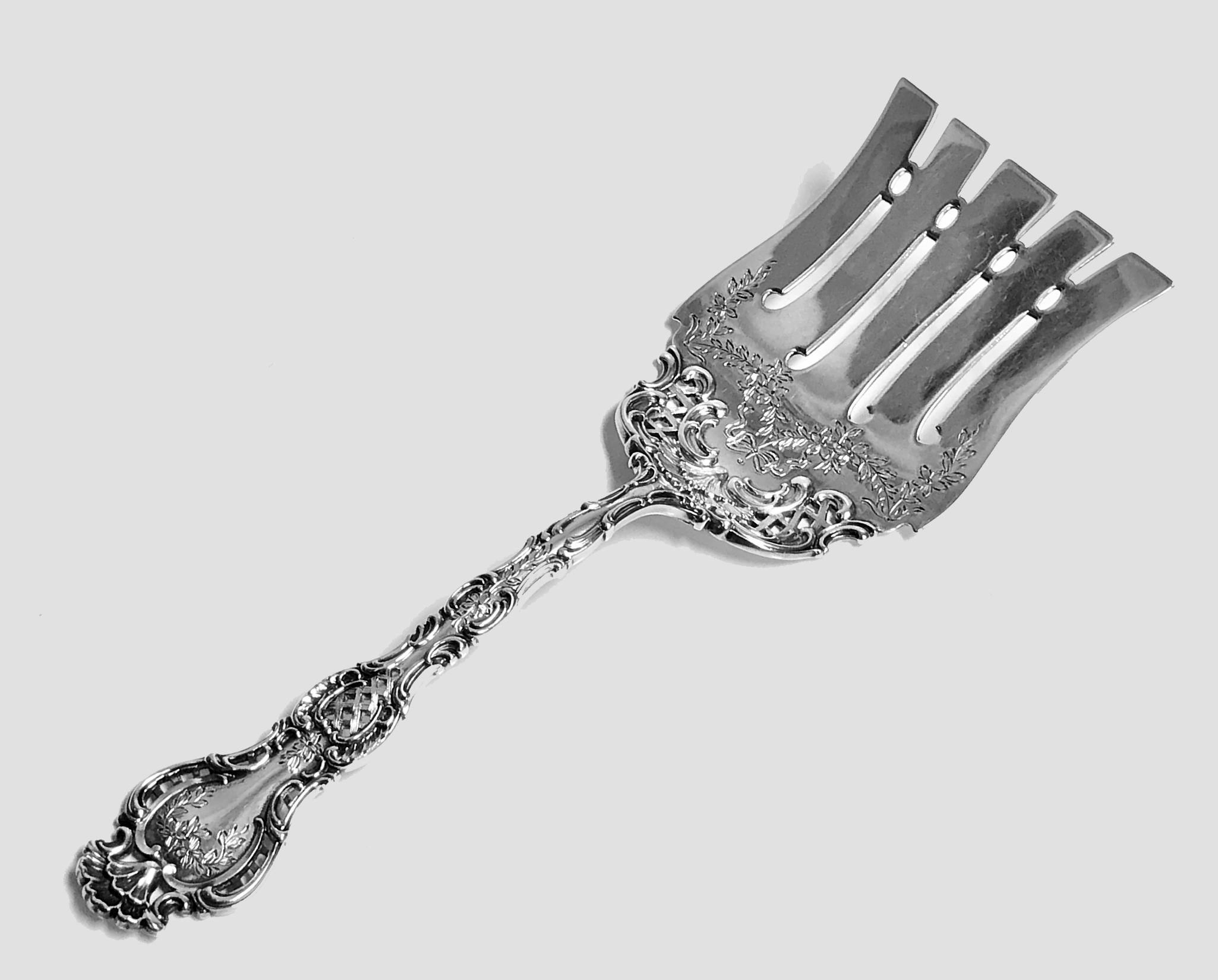 Durgin Gorham Fancy Regent sterling silver Asparagus Fork, circa 1910. Scrolled and pierced handle with engraved flowers and scallop shell terminal. Flat lifter with concave sides, the tines with pierced scroll ovals between. A rare early piece in