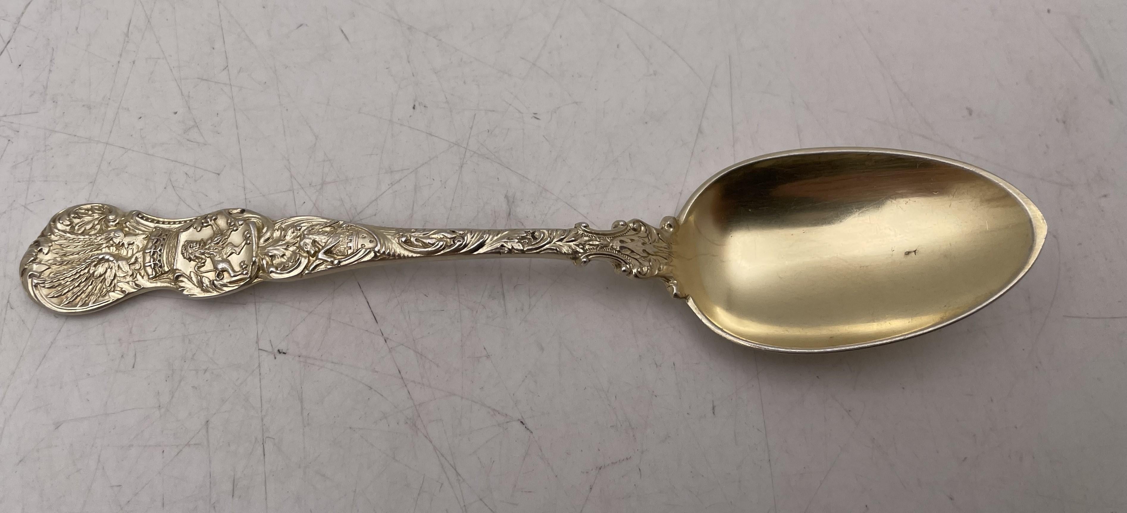 Durgin set of 12 gilt sterling silver teaspoons in the Heraldic pattern, beautifully adorned with a lion, a castle, and a crown, among other motifs. They measure 6'' in length and bear hallmarks and a monogram as shown. 

Please feel free to ask us