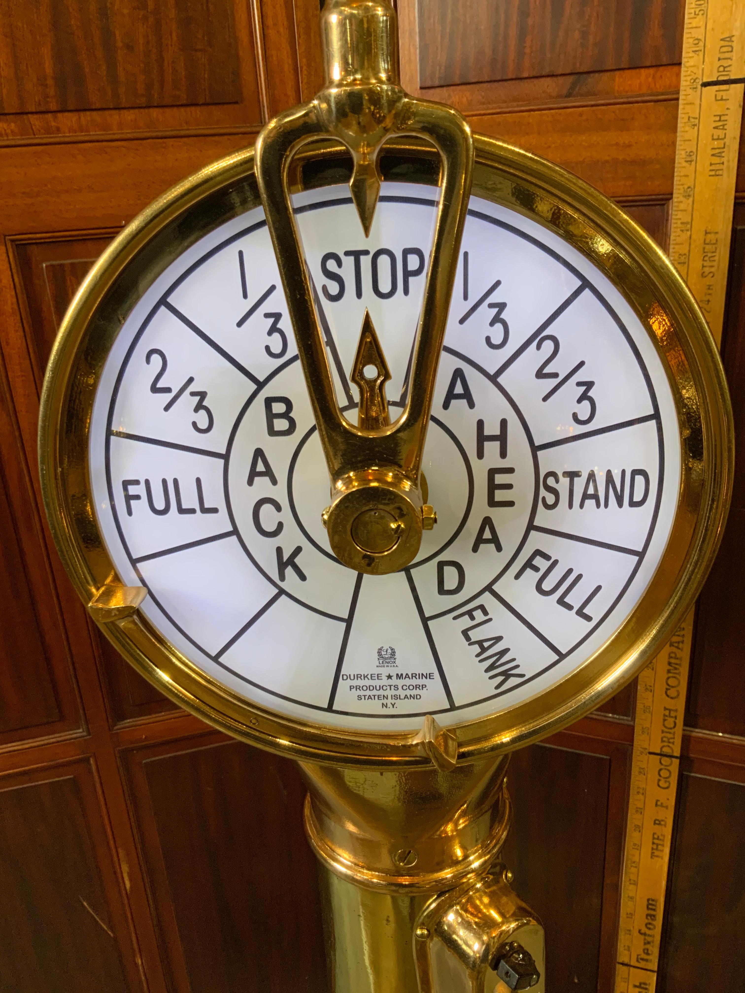 Here is a highly polished and fully restored ships engine order telegraph. It has been meticulously polished and lacquered to a very high gleam. The bells ring, it has been illuminated and also mounted to a thick mahogany base. Weight is 83 pounds.