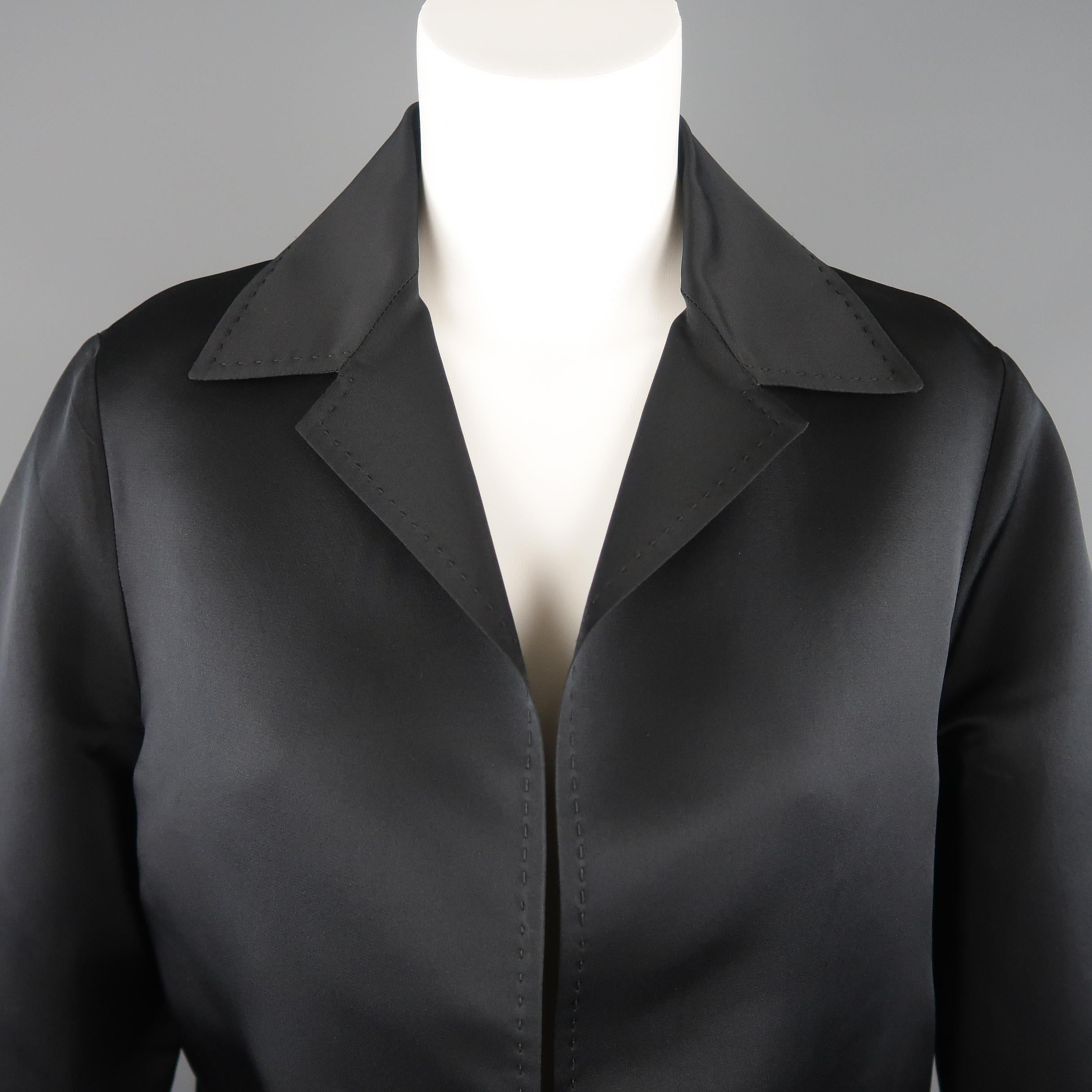 DUSAN jacket comes in black silk satin with a pointed collar, slanted pockets, open front, and top stitching throughout. Made in Italy.
 
Excellent Pre-Owned Condition.
Marked: M
 
Measurements:
 
Shoulder: 16 in.
Bust: 46 in.
Sleeve: 24 in.
Length: