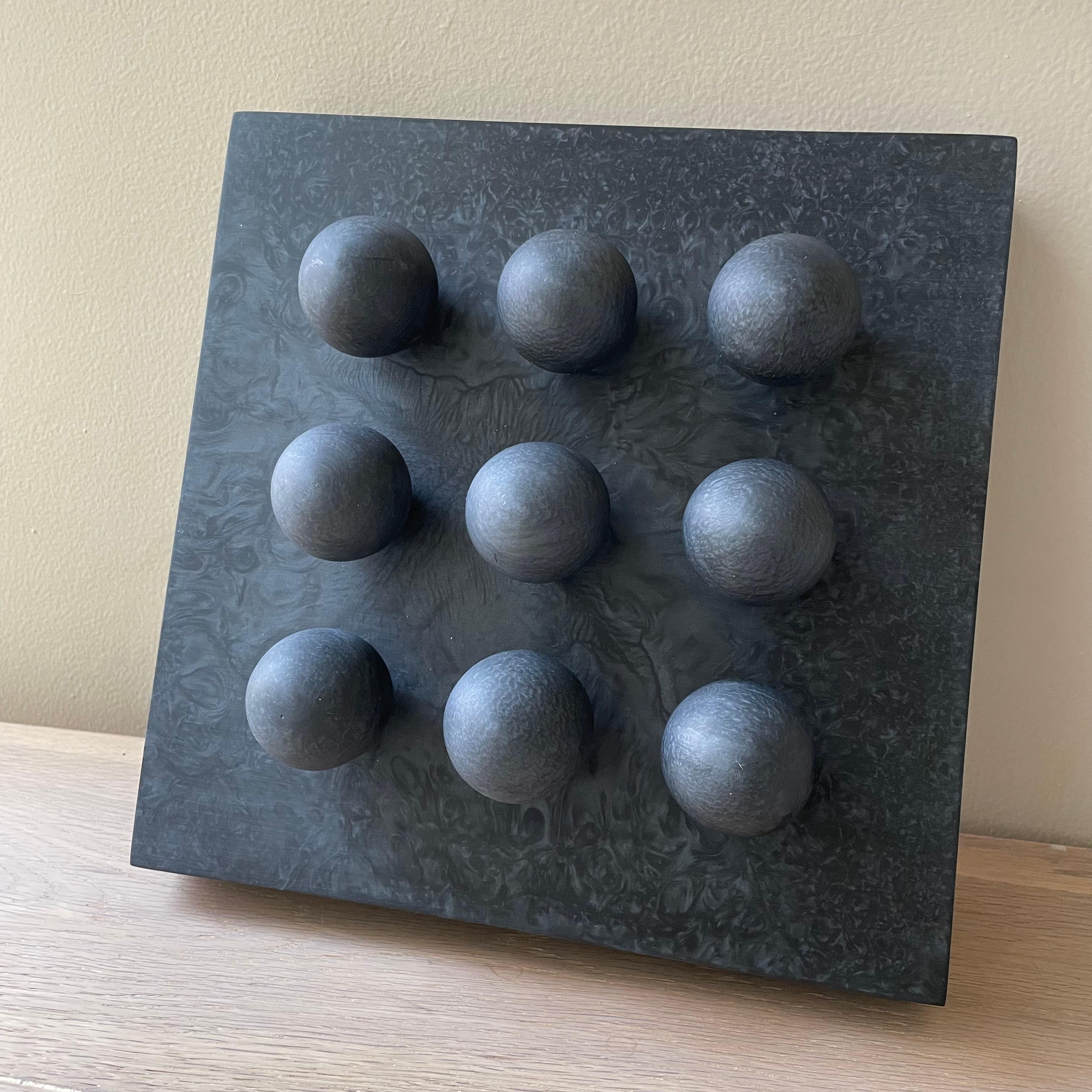 It is a geometric, simple and contemporary piece with a lot of personality that will complement any space.
You can hang the piece on a wall or place it on a table and lean it against the wall.

Material: black pearl resin in satin