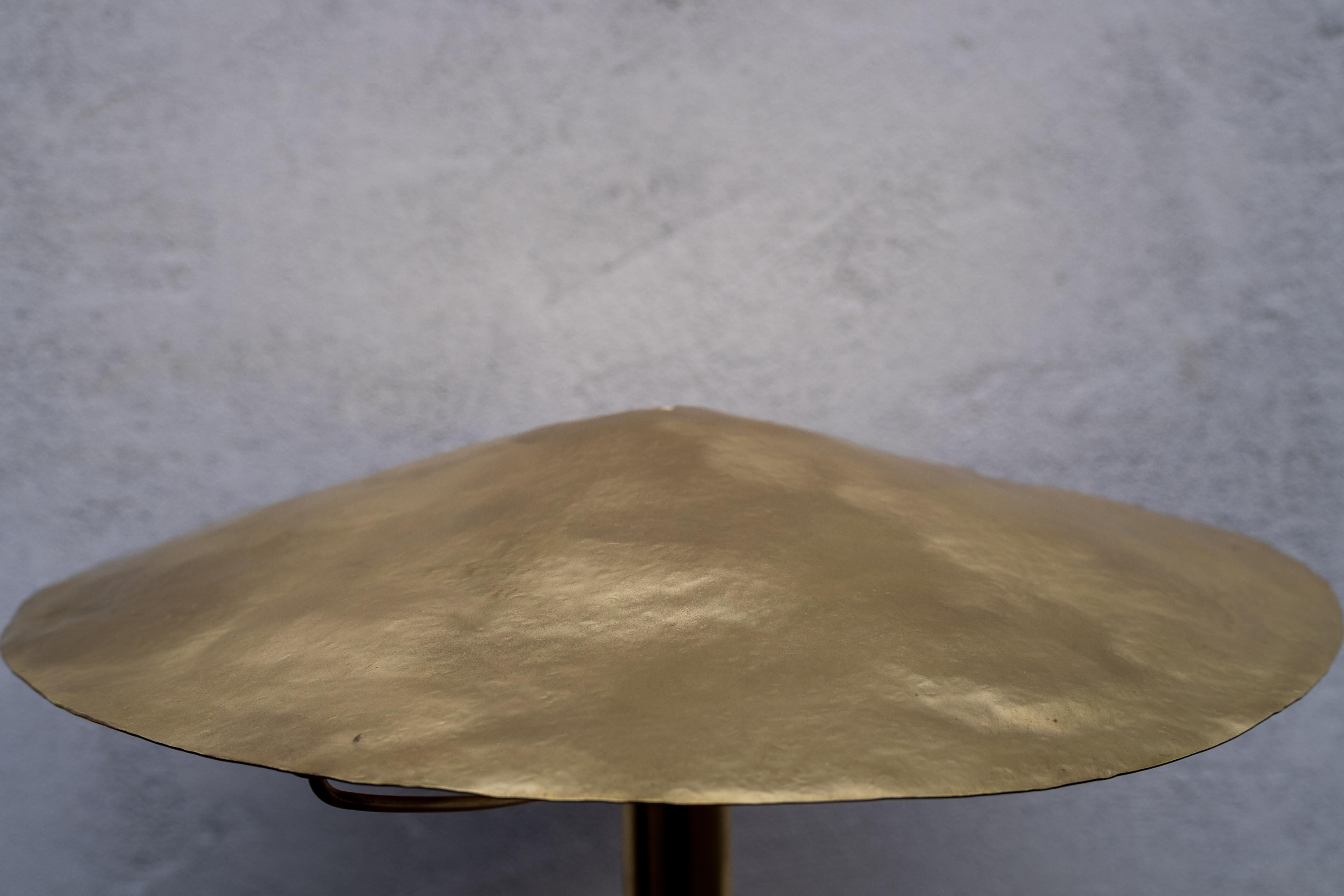 The Dusk Lamp is a solid brass, hand made, table lamp. Manually machined contours balance with hand hammered textures. Lit or not, each part of this lamp is made to embrace the light  present.

A push button switch sits beside the lamp, allowing