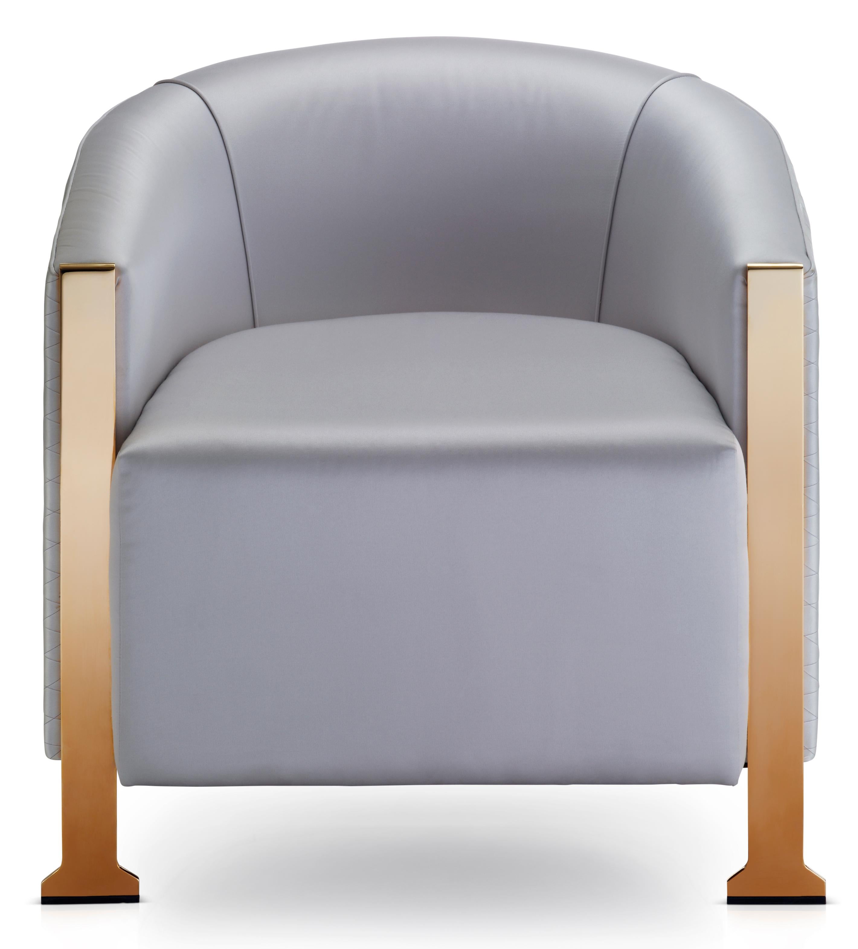 This beautiful curved tub chair stands on polished brass metal legs to bring a touch of quiet glamour to any space. The deep padded inner seat and back provides superior comfort. 

The chair is upholstered in specially selected elegant fabrics but