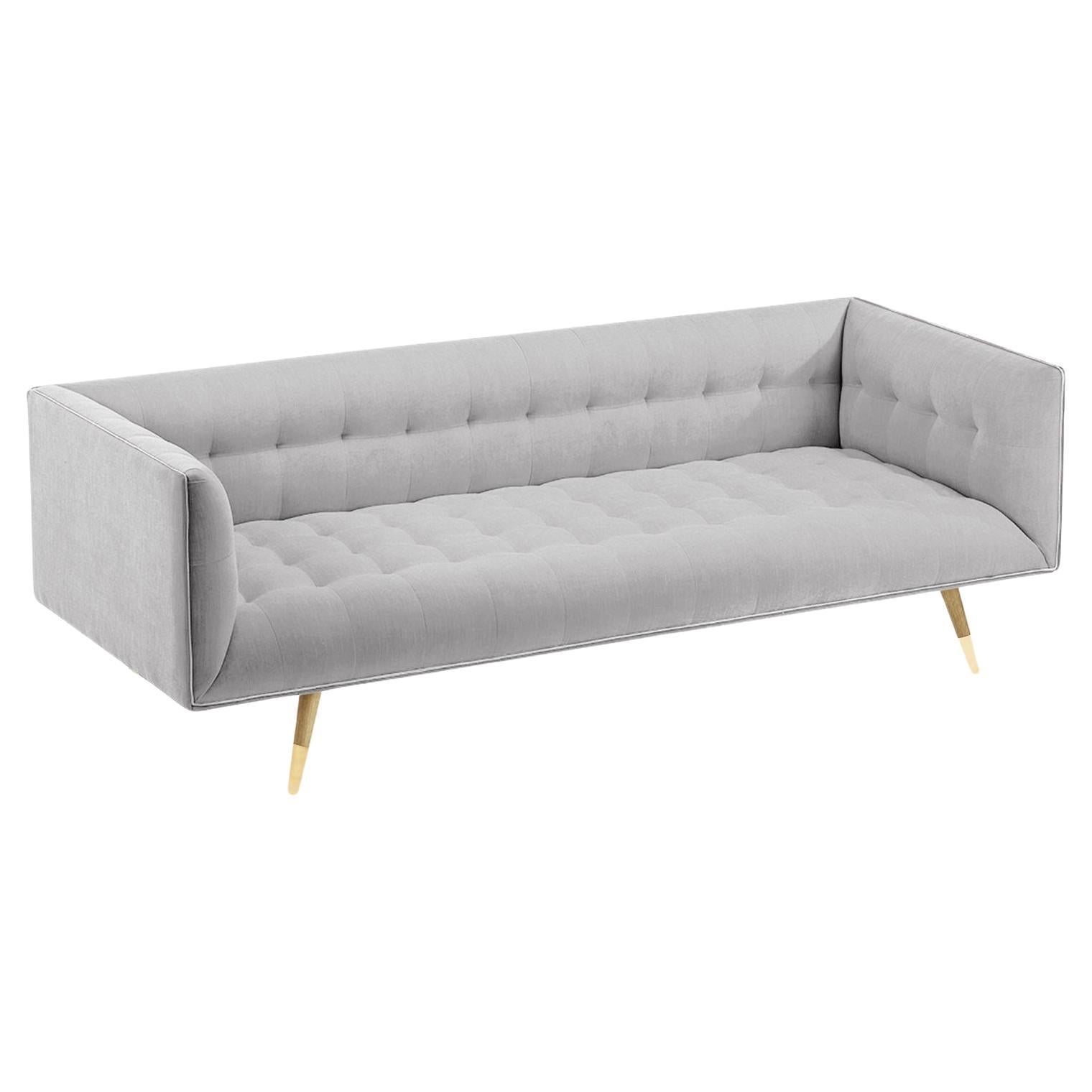 The Dust Sofa is constructed in solid wood, with an elevated tufted elegant look and a comfortable seating. Handmade with a solid wood base and wood legs with a stylish polished brass metal feet detail. Available as an option.

The Dust Sofa is