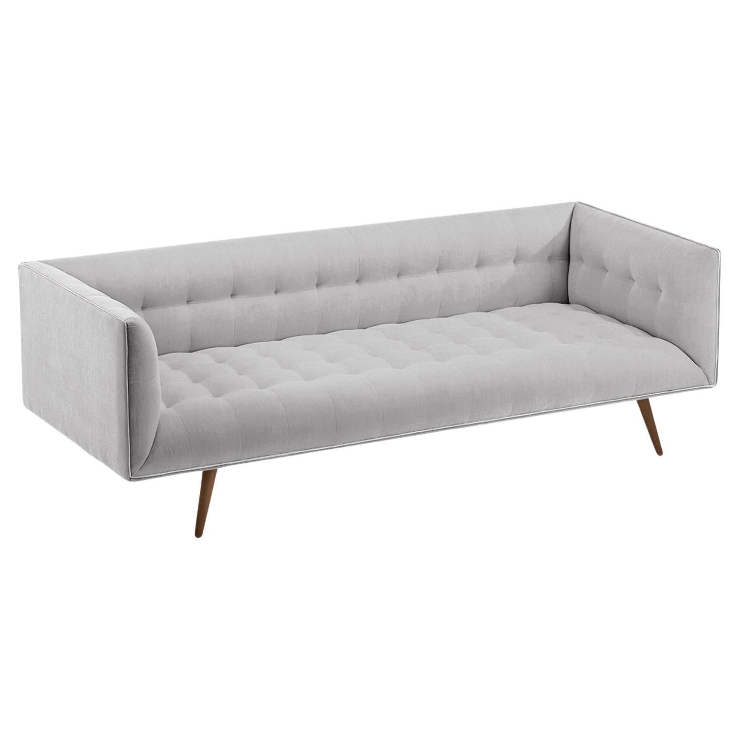 The Dust Sofa is constructed in solid wood, with an elevated tufted elegant look and a comfortable seating. Handmade with a solid wood base and wood legs with a stylish polished brass metal feet detail. Available as an option.

The Dust Sofa is