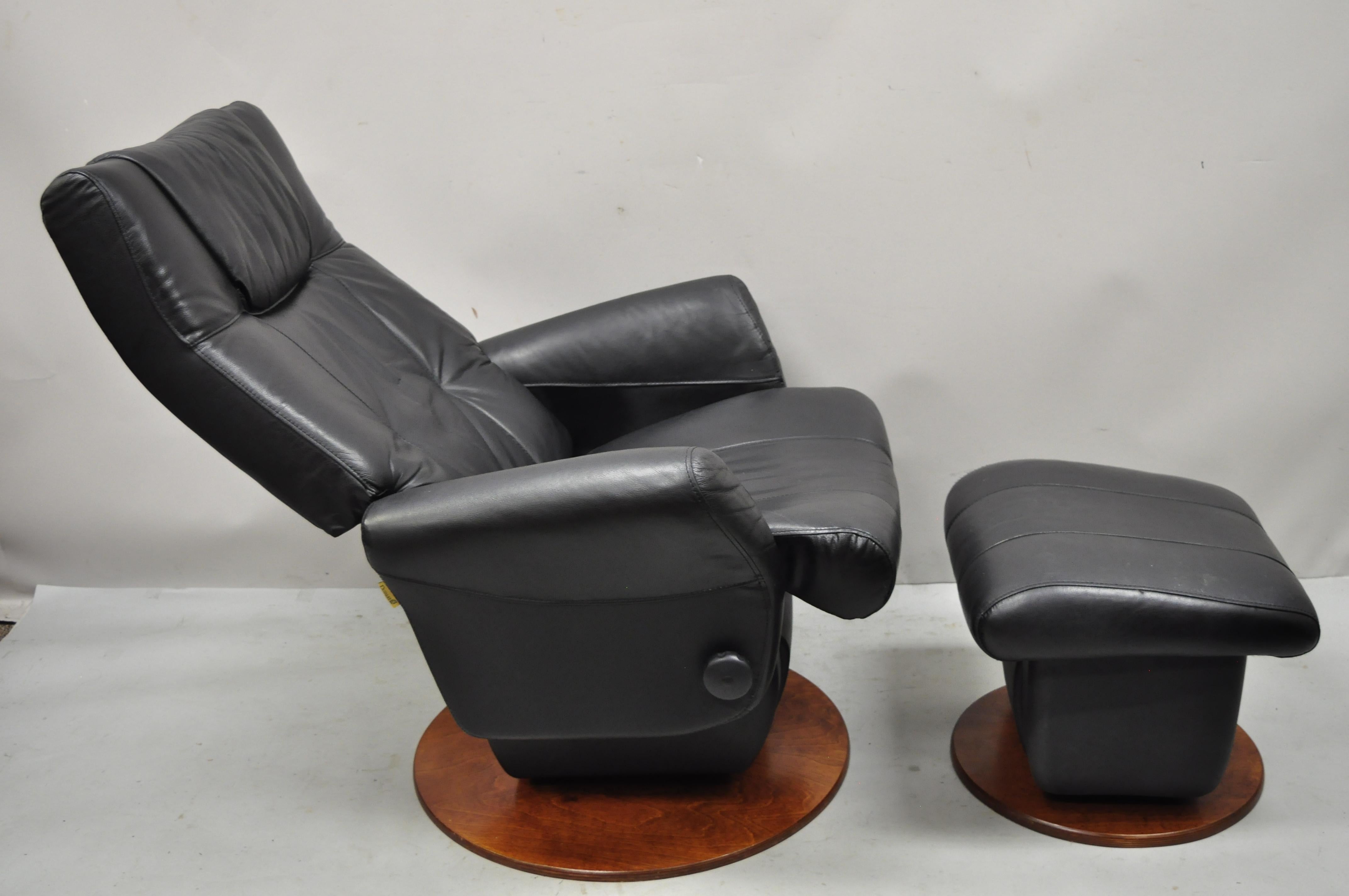Dutailier black leather avant glide glider swivel recliner chair and ottoman. Item features swivel, tilt, recliner lounge chair, tilting/rocking ottoman, black leather upholstery, original label, quality Canadian craftsmanship, great style and form.