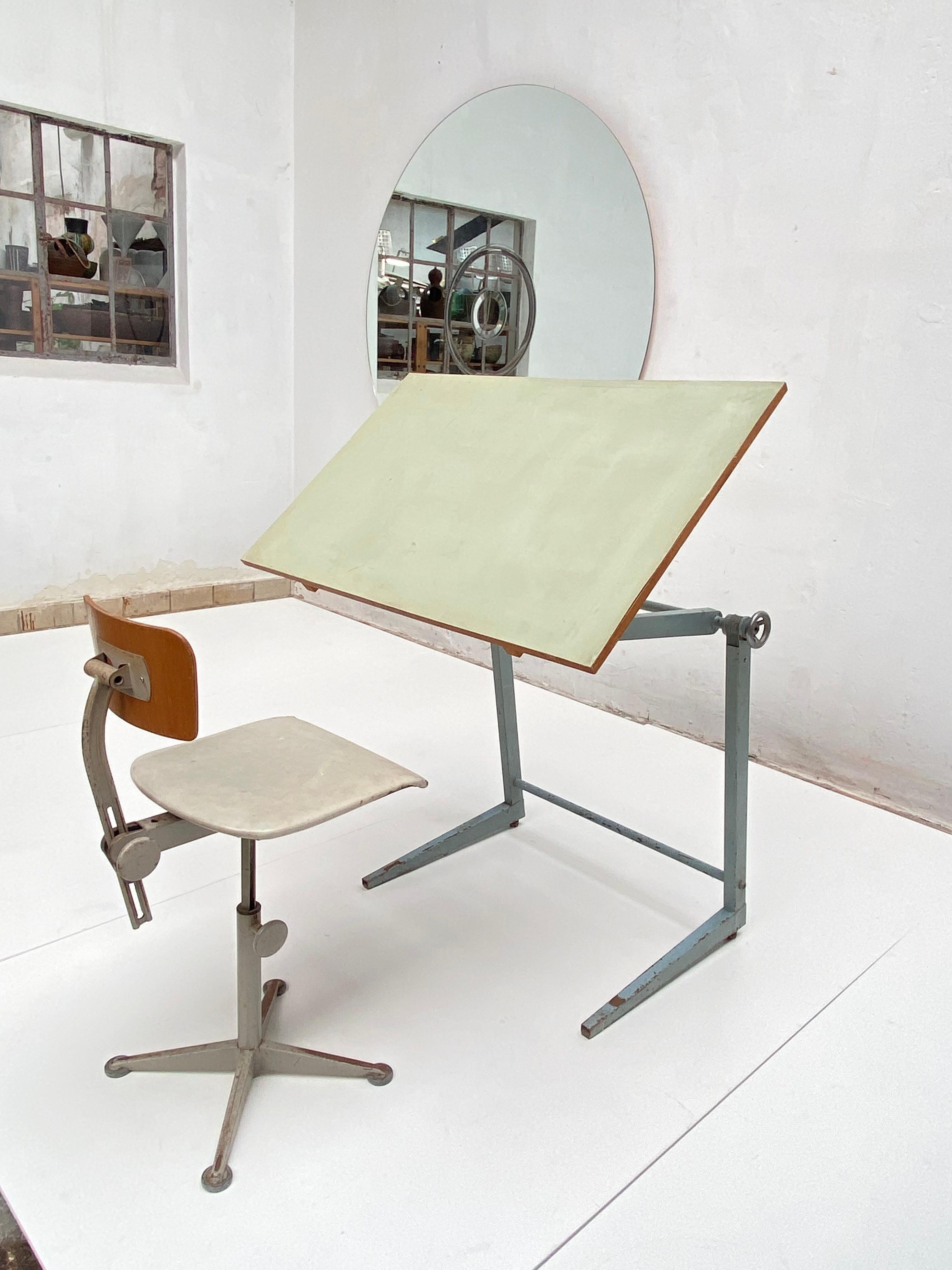 1950's adjustable drafting table produced by Marko and a working stool by Dutch designer Friso Kramer for Ahrend - De Cirkel approximately manufactured 1960

The table can be adjusted in height and angle, locked by tightening or unlocked by