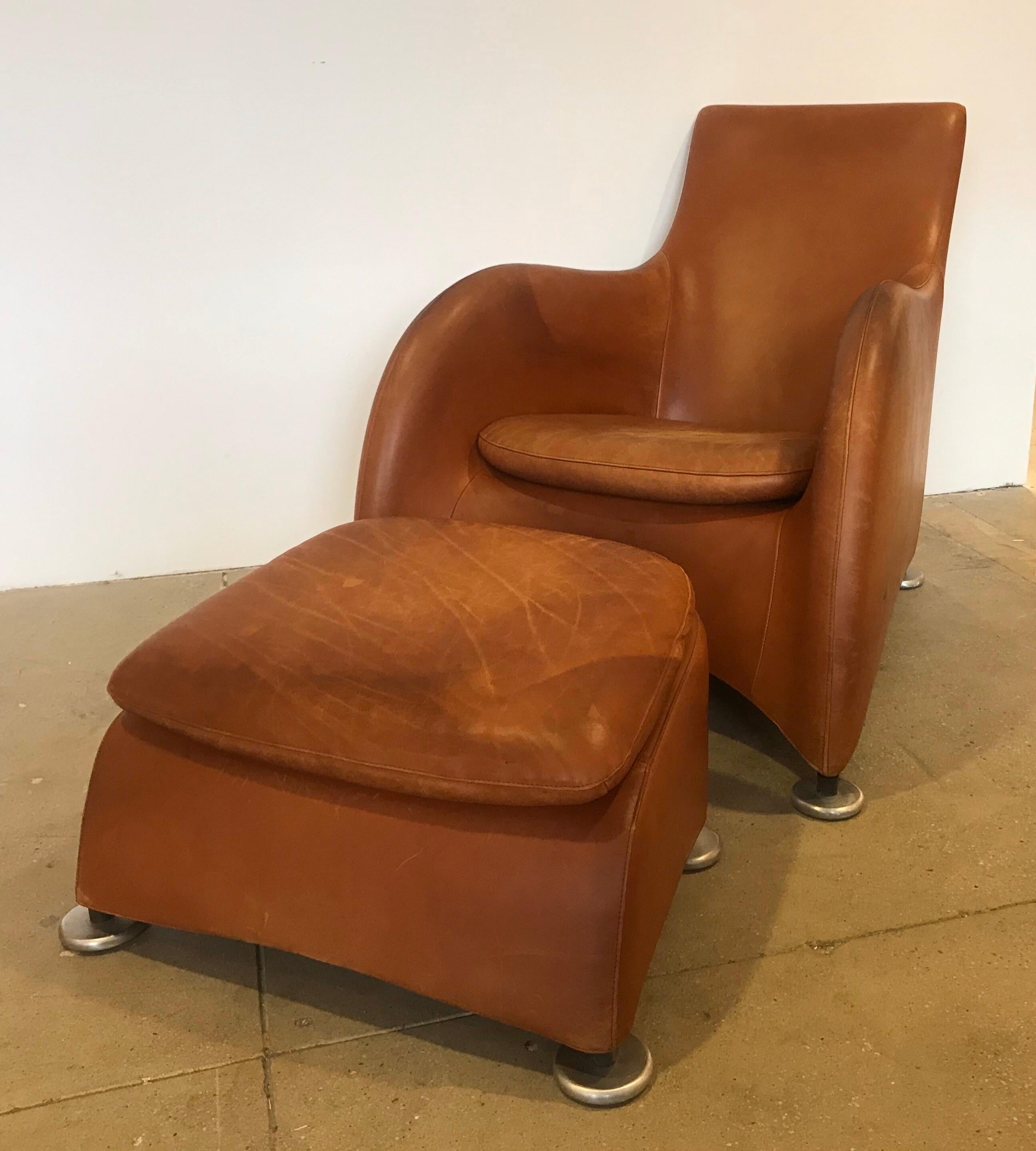 A wonderful 1990s cognac leather lounge chair and ottoman by Dutch maker, Montis. The leather has plenty of age and patina for a worn comfortable looks. No rips or tears.