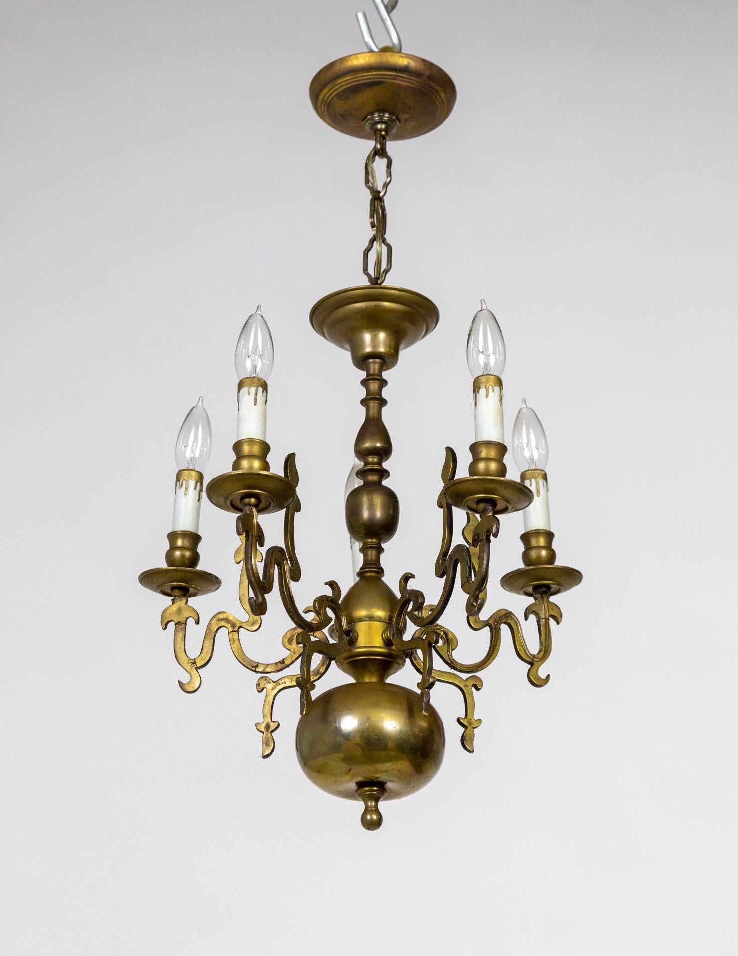 A 19th century Dutch chandelier with Renaissance Revival flame accents. A rich patina on a solid brass, turned-style form with 5 wavy, candlestick arms. Relatively petite size, 17” diameter x 18” height, 28” overall height including chain and