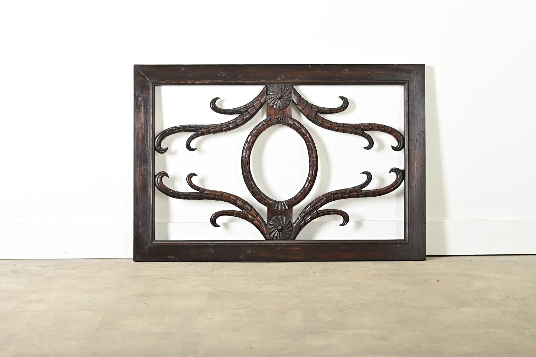 A dramatic frame of carved mahogany found in the Netherlands, likely a 19th century architectural detail such as a transom above a doorway. This pierced window is without glass allowing one to fully appreciate the skilled carvings of talons