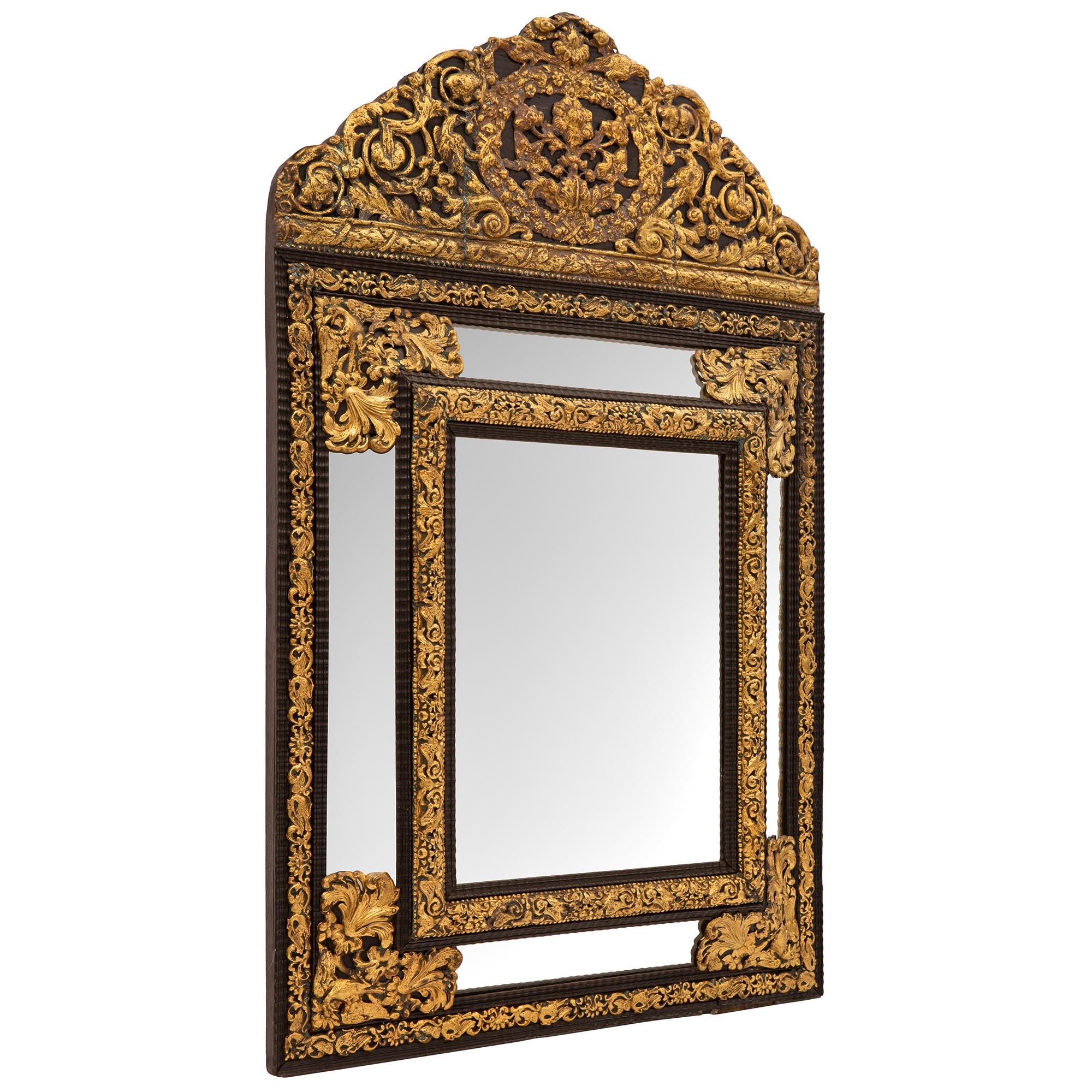 A most attractive Dutch 19th century ebony and gilt metal double framed mirror. The mirror retains all of its original mirror plates throughout with the central plate set within a mottled ebony border with a wave like design and an impressive