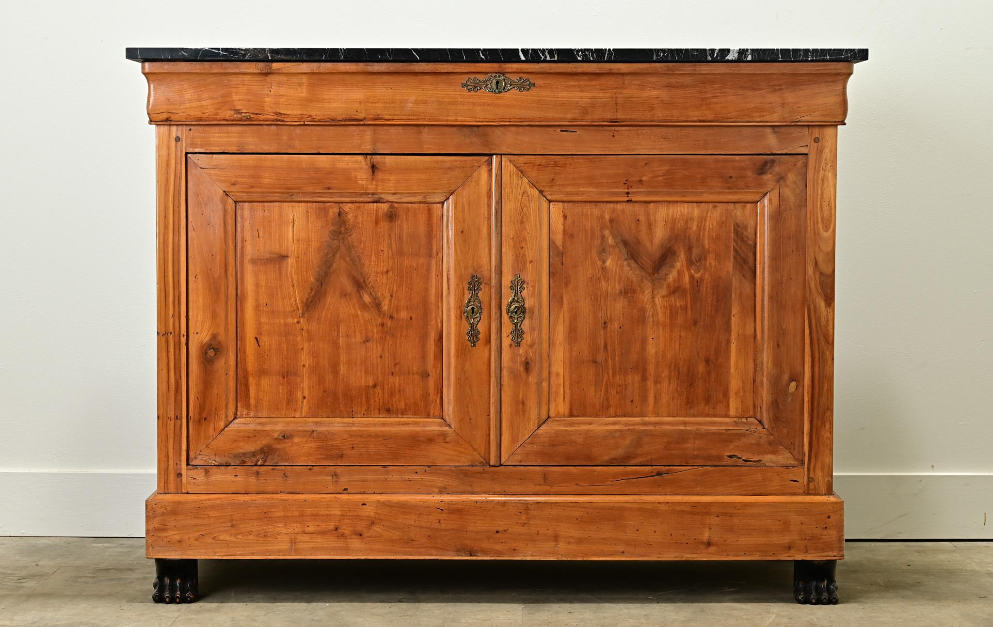 A handsome Dutch fruitwood buffet with ebonized details blends the French styles of Louis Philippe and Empire. A new black marble top sits above a long single drawer with a working lock surrounded by a decorative escutcheon plate. Below is a pair of