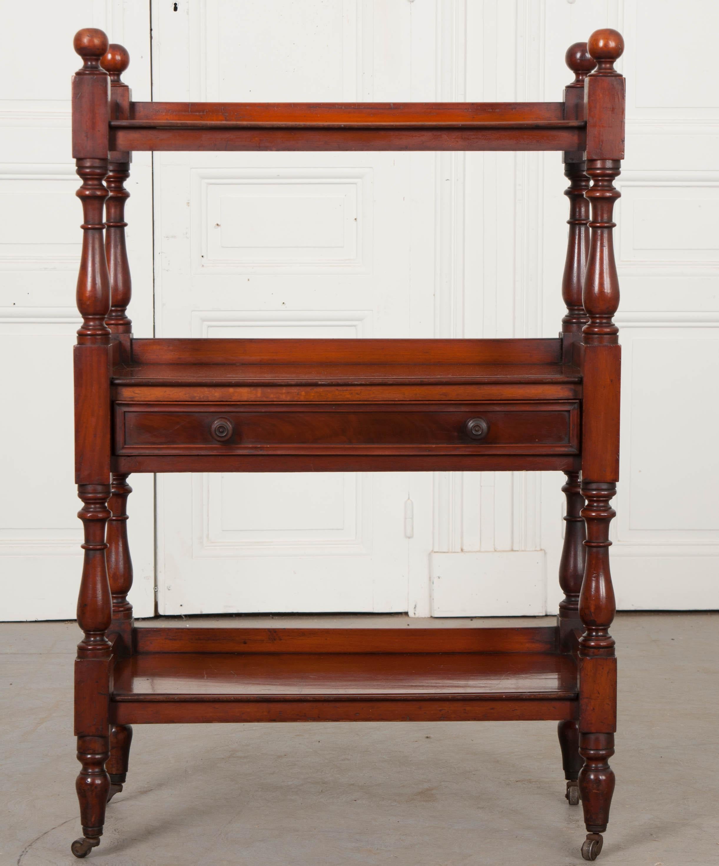 This wonderful three-tier mahogany tea trolley, circa 1860, is a Dutch interpretation of traditional English Georgian style and features a second tier drawer for storing flatware and serving utensils. The color is very rich and the excellent patina