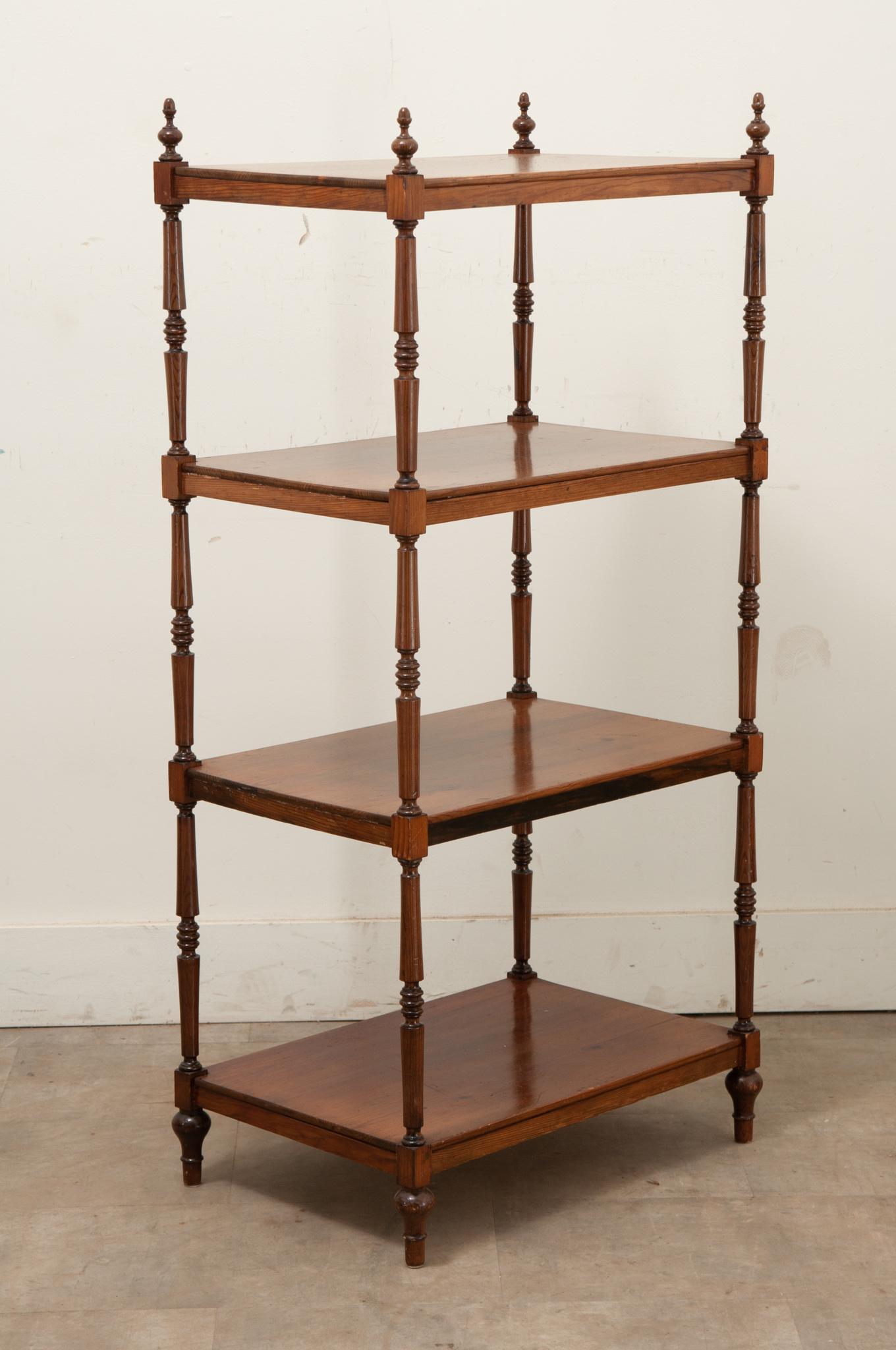 A tall etagere made of pine is the perfect storage addition to any interior. Light weight in style this shelf is topped with finials over four well spaced shelves all held together with decorative turned pine legs. Be sure to take a look at the