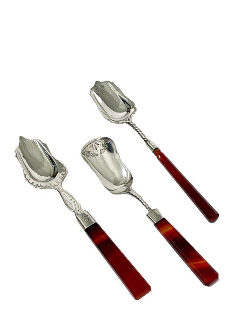 Dutch 19th century silver sugar spoons with agate handles

Dutch Biedermeier sugar spoons of silver with engraving and agate handles. 
1 spoon has an octagonal round agate handle and the other 2 hexagonal flat agate handle
The 2 with turned