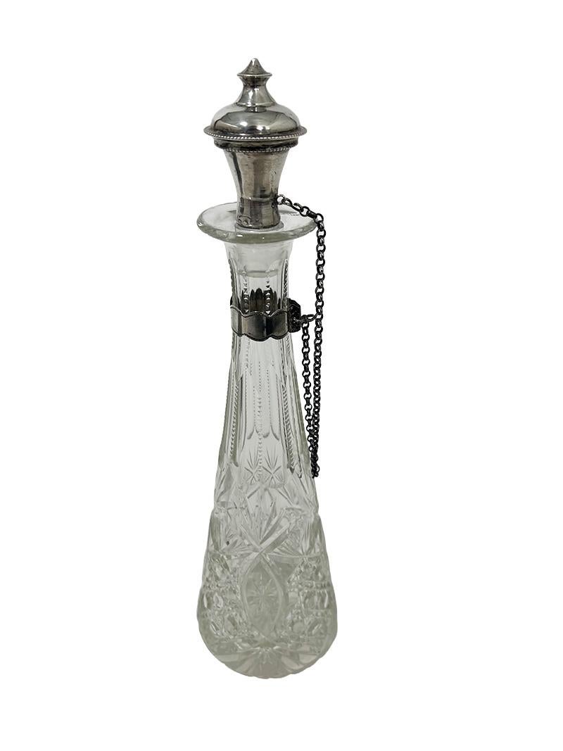 Dutch 19th Century small crystal glass cut decanter with silver

A  very lovely and very small crystal cut decanter with a silver stopper and attached to a chain at the neck of the decanter and they are made of Dutch silver. The stopper and the band
