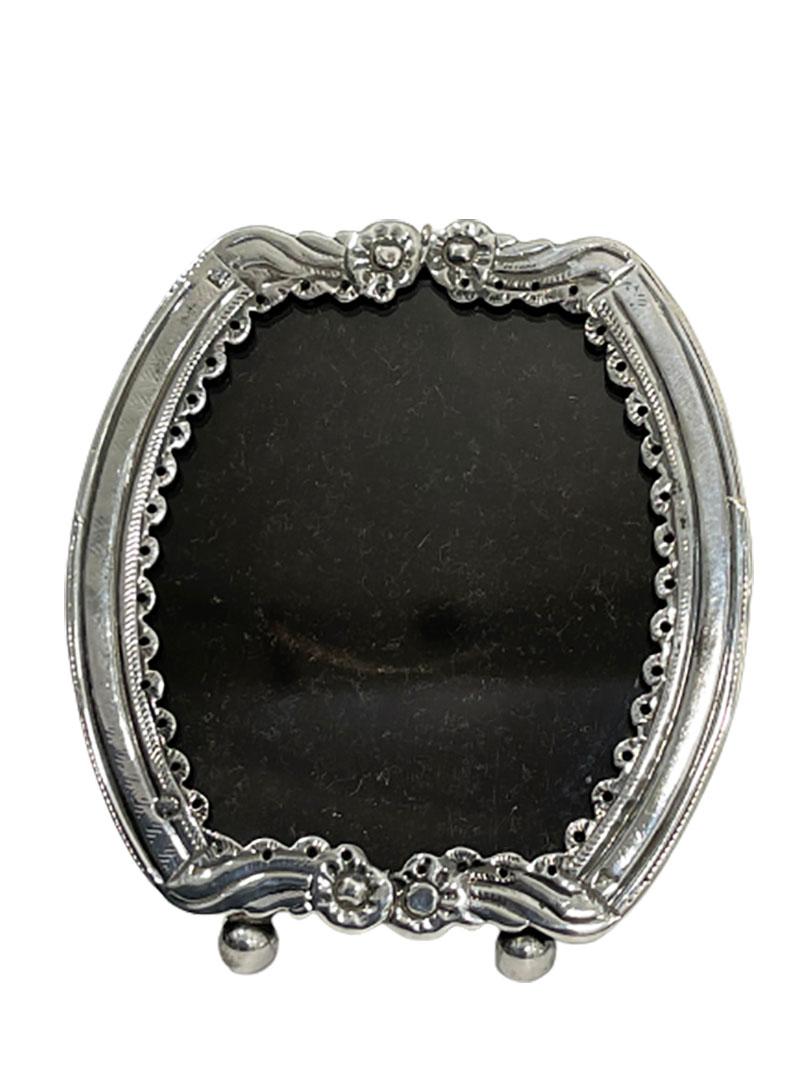 Dutch 19th century small silver photo frame

A Dutch small standing silver photo frame in mirror image 19th Century. 
Dutch silver photo frame on ball feet. 
The photo frame can be placed as standing, but also has an eyelet to hang it up
Many