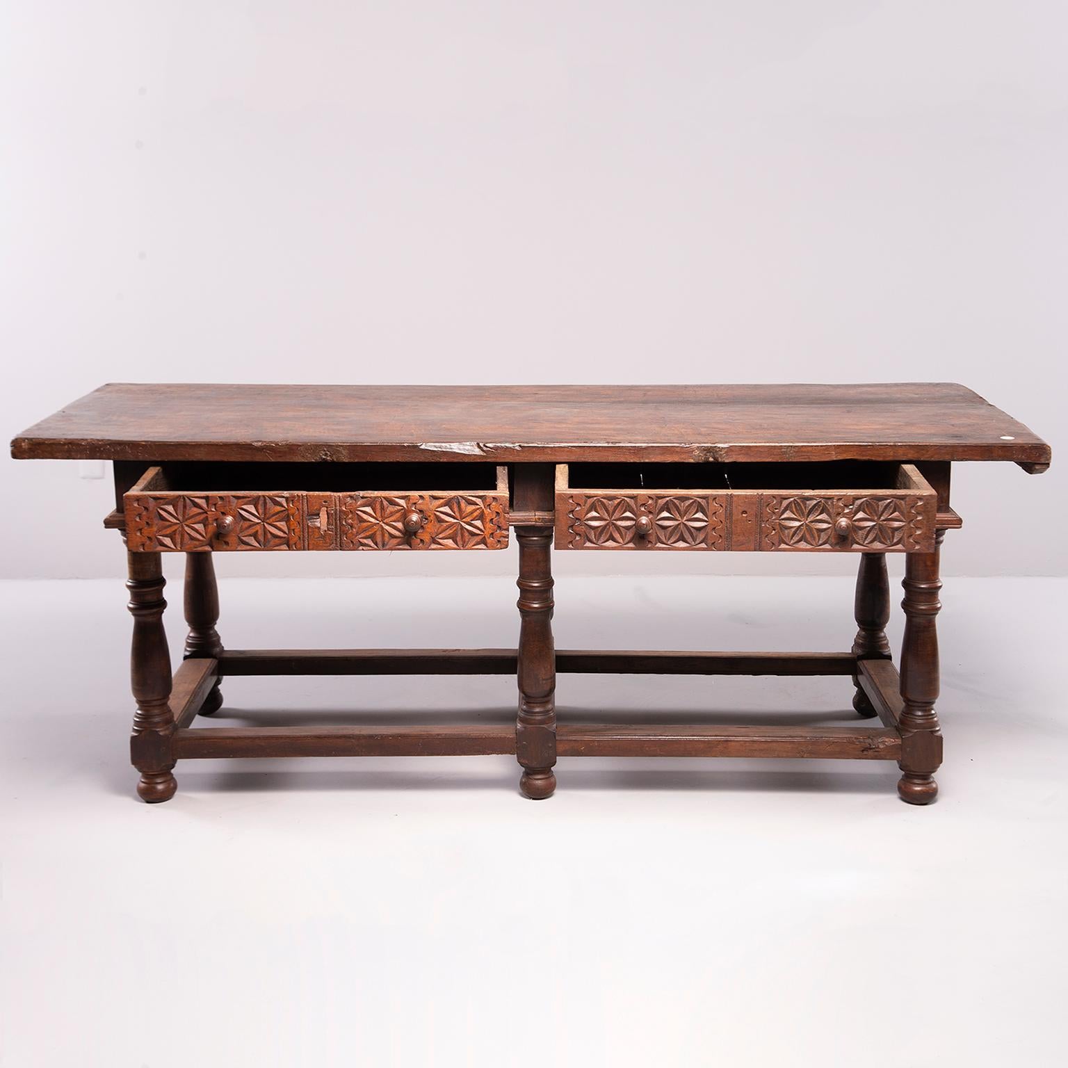 Large, six-legged all-original carved walnut  Portuguese table features turned legs with sturdy stretcher, carved details on sides, back and two drawer fronts, circa 1780s. Table top shows wear, patina, worm holes and has a smooth finish. Impressive
