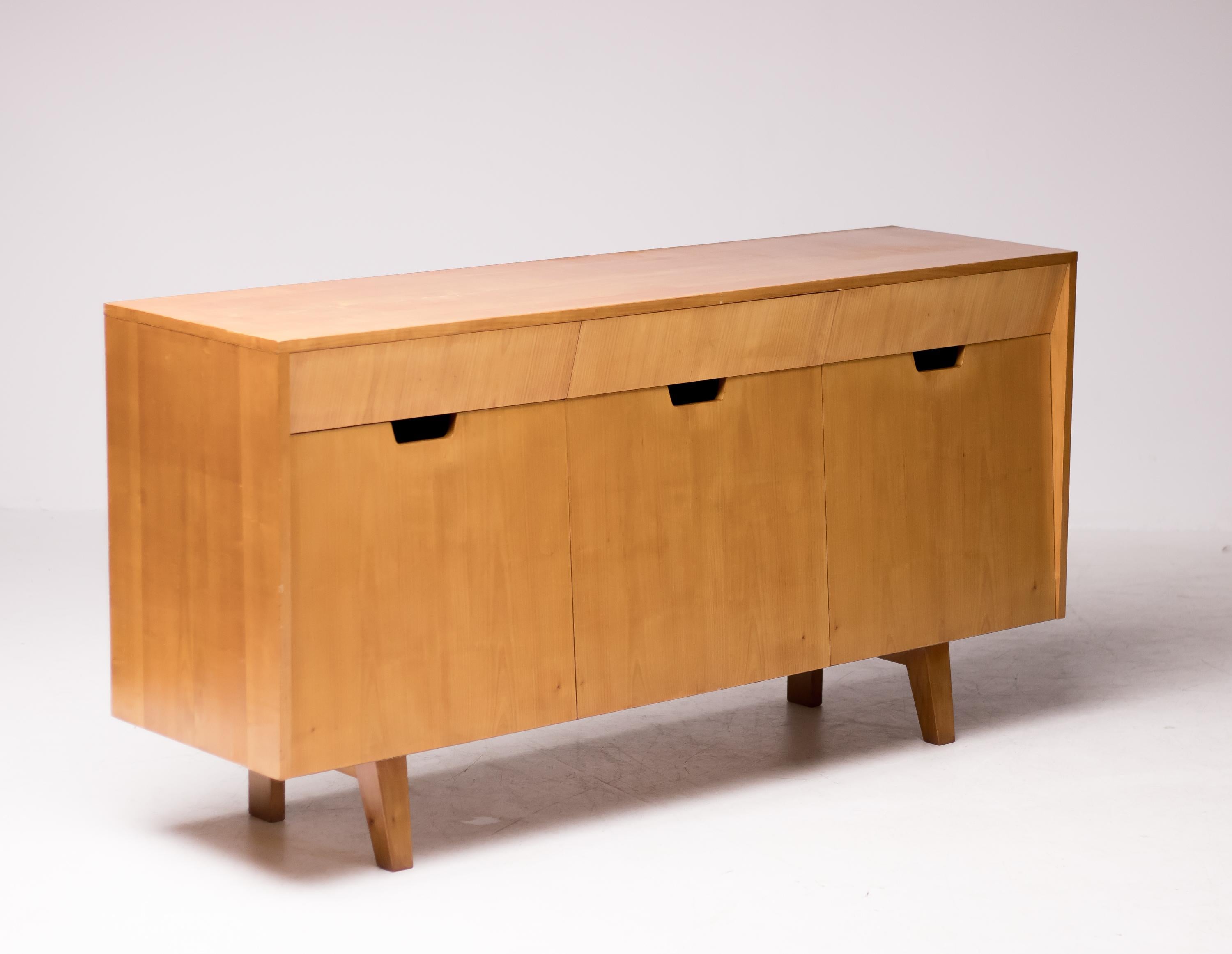 Beautiful Mid-Century Modern sideboard with smart Minimalist design making door and drawer handles superfluous.
