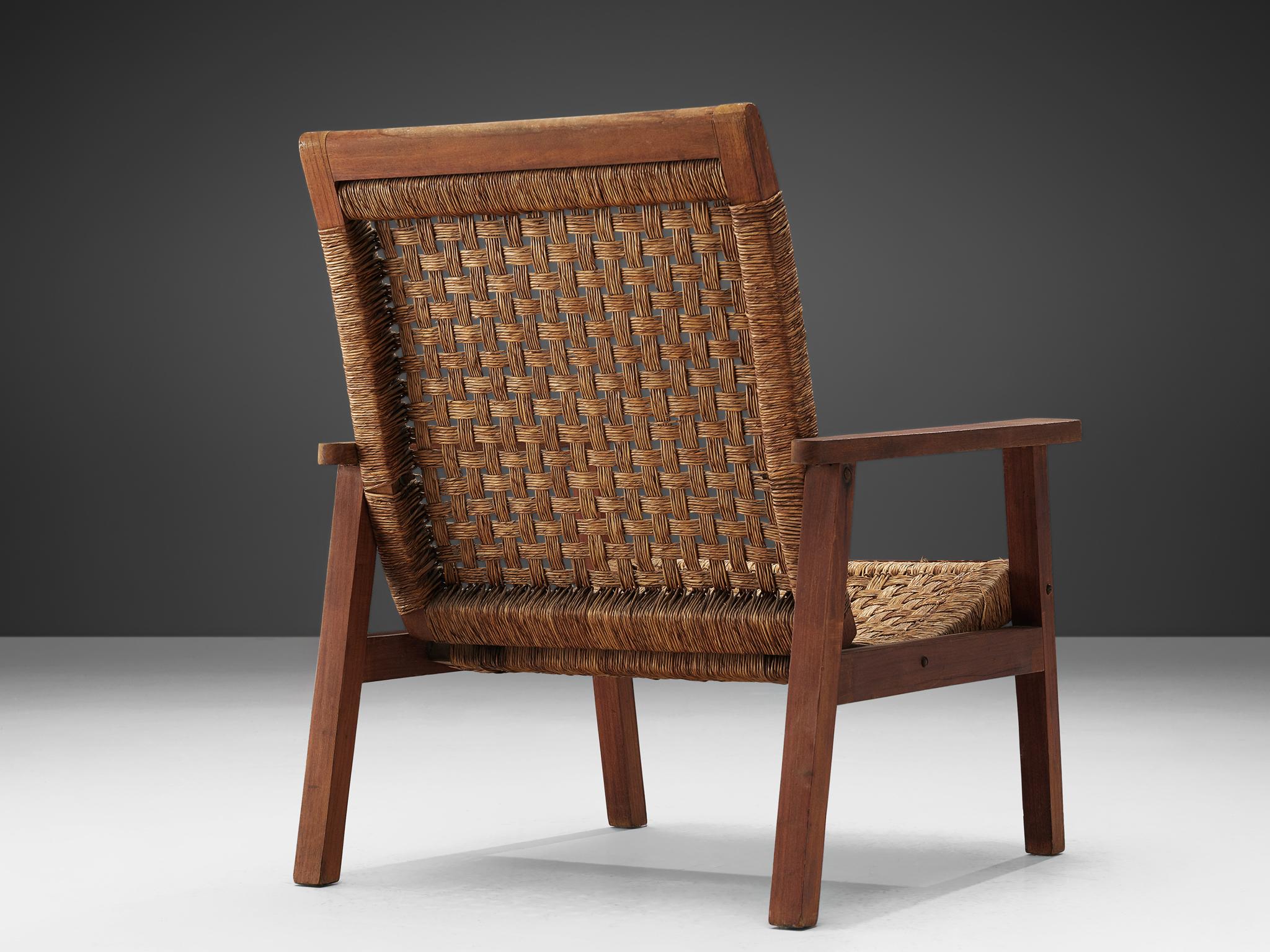 Armchair, stained wood and woven rope, Netherlands, 1940s.

This lounge chair is executed in wood and rope. The design of this chair is minimalistic in a puritan way. The woven seat and backrest are simplistic, but give the sitter a comfortable