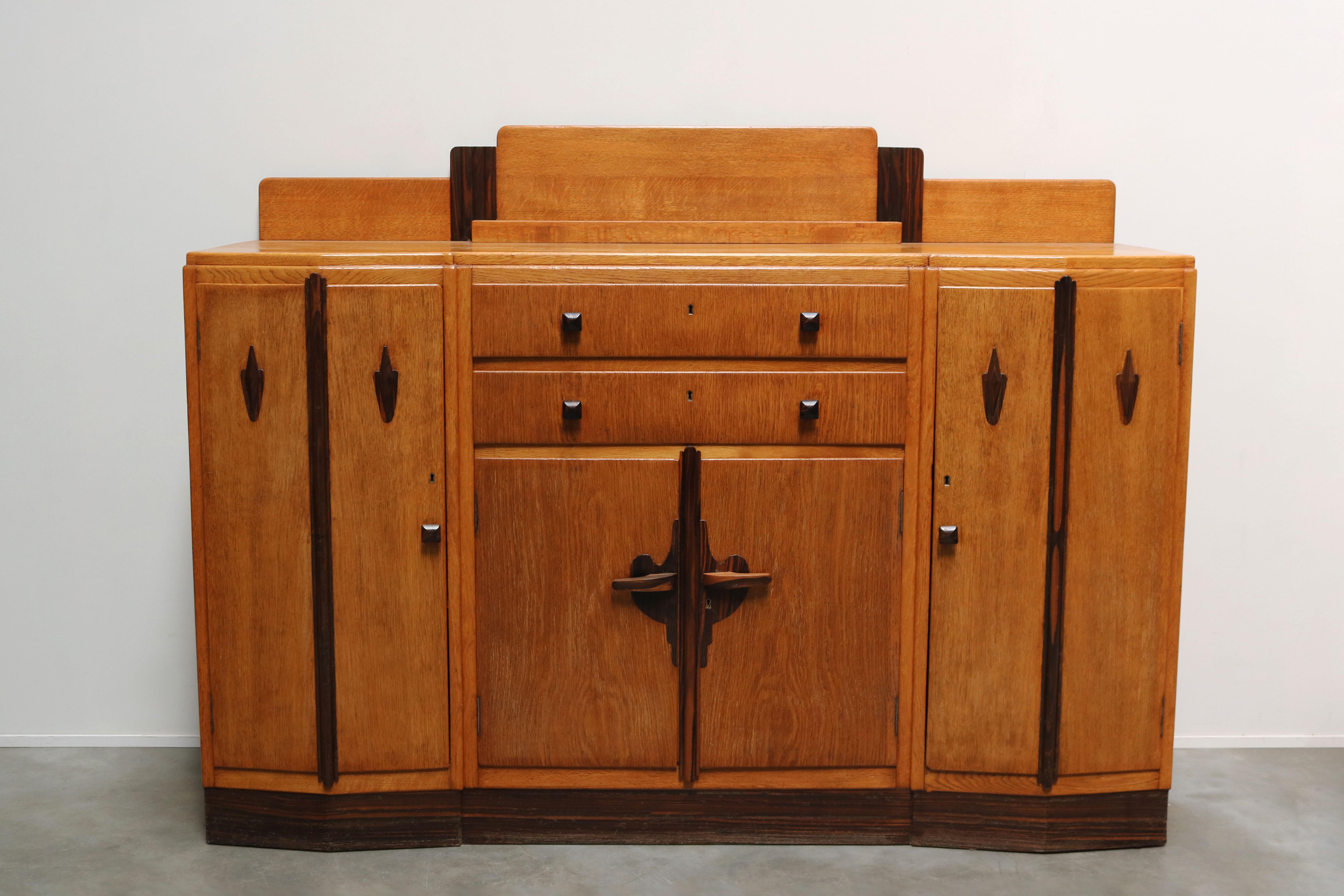 Superb Dutch Art Deco sideboard / credenza in the Amsterdam School design style by Brunott. 
Brunott is famous for high quality Amsterdam school design and this sideboard perfectly reflects that. 
Made from Solid European oak with exotic wood