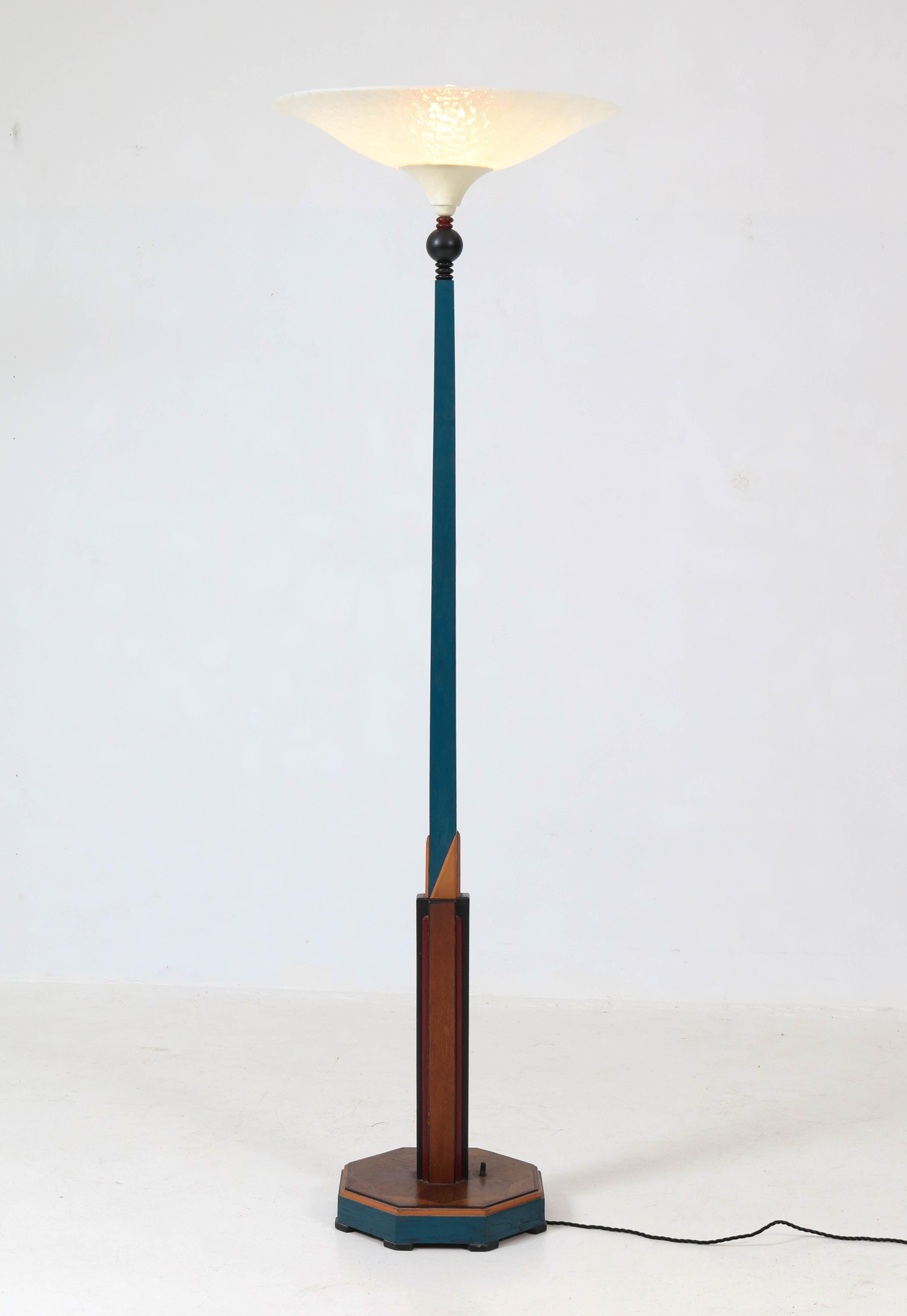 Offered by Amsterdam Modernism:
Elegant oak Art Deco Amsterdam School floor lamp with milk glass shade.
This floor lamp is transformed in the sixties by painting the oak lampbase
and the milk glass shade has been added for a French Art Deco look.
In