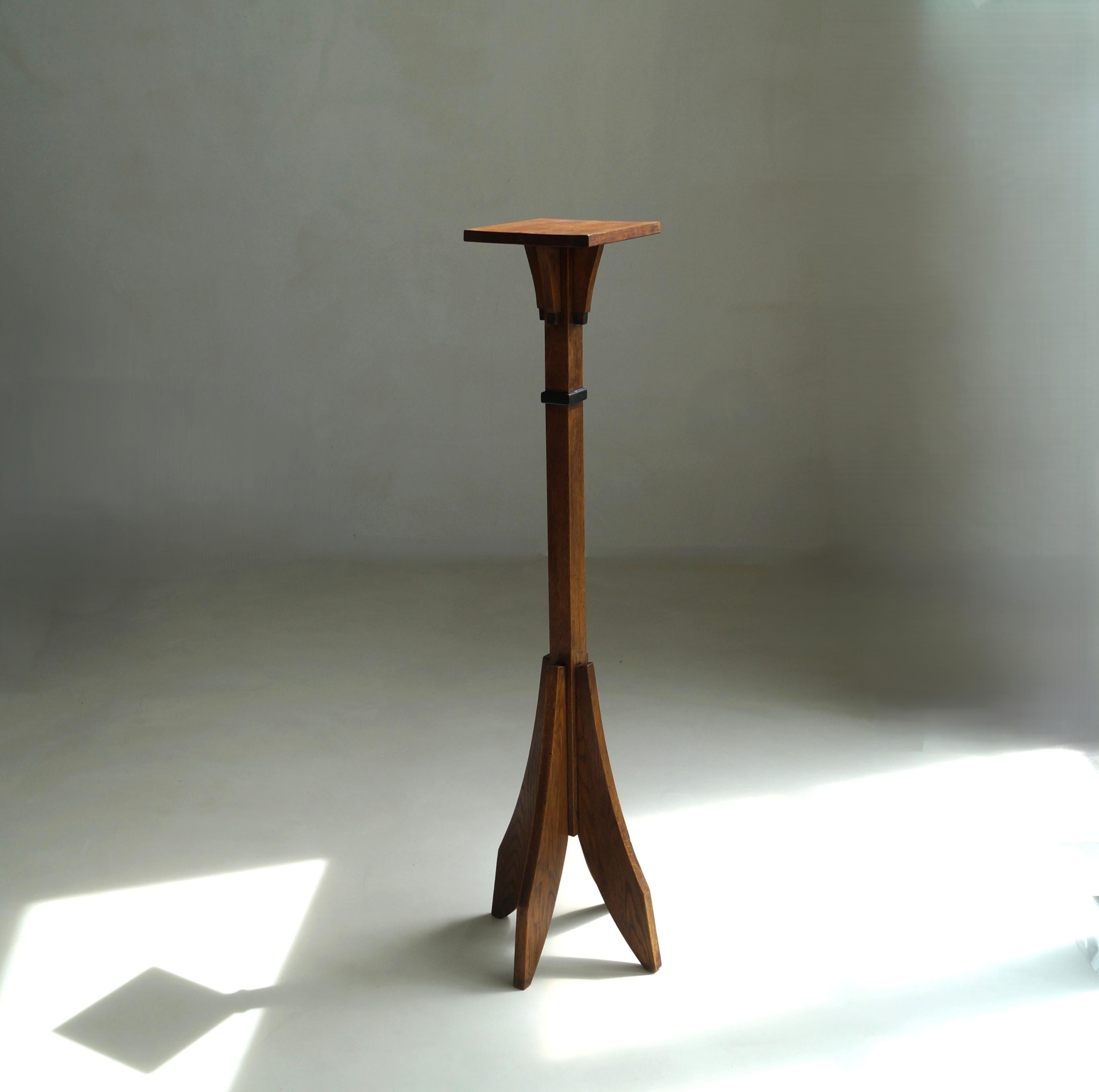 A tall Amsterdam School/ Arts & Crafts pedestal in solid oak, 1920s to 1930s. The pedestal nearly comes up to one's shoulder which is quite extraordinary (most pedestals are around the 90 cm in height). It is handcrafted, woodcarved and has subtle
