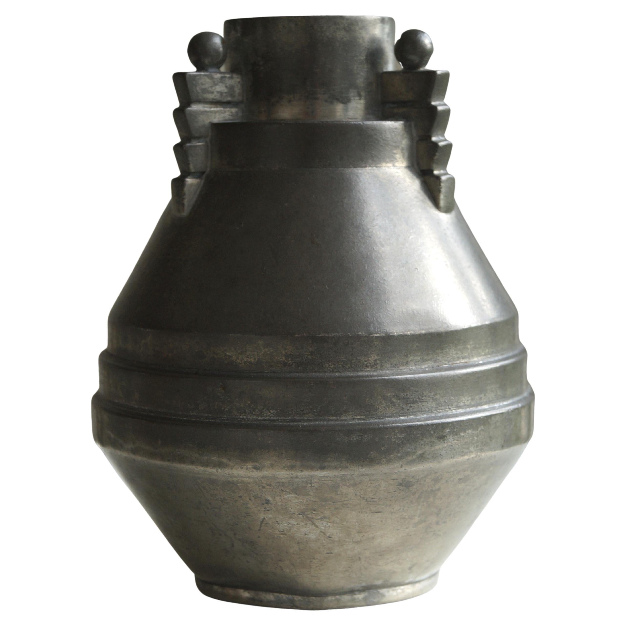 A decorative and stylish pewter vase by Dutch manufacturer Daalderop, c. 1925. Signed underneath with the stamp from the 1920s. The piece is in good condition regarding it is a 100 years old. The decorations with the small solid balls and the