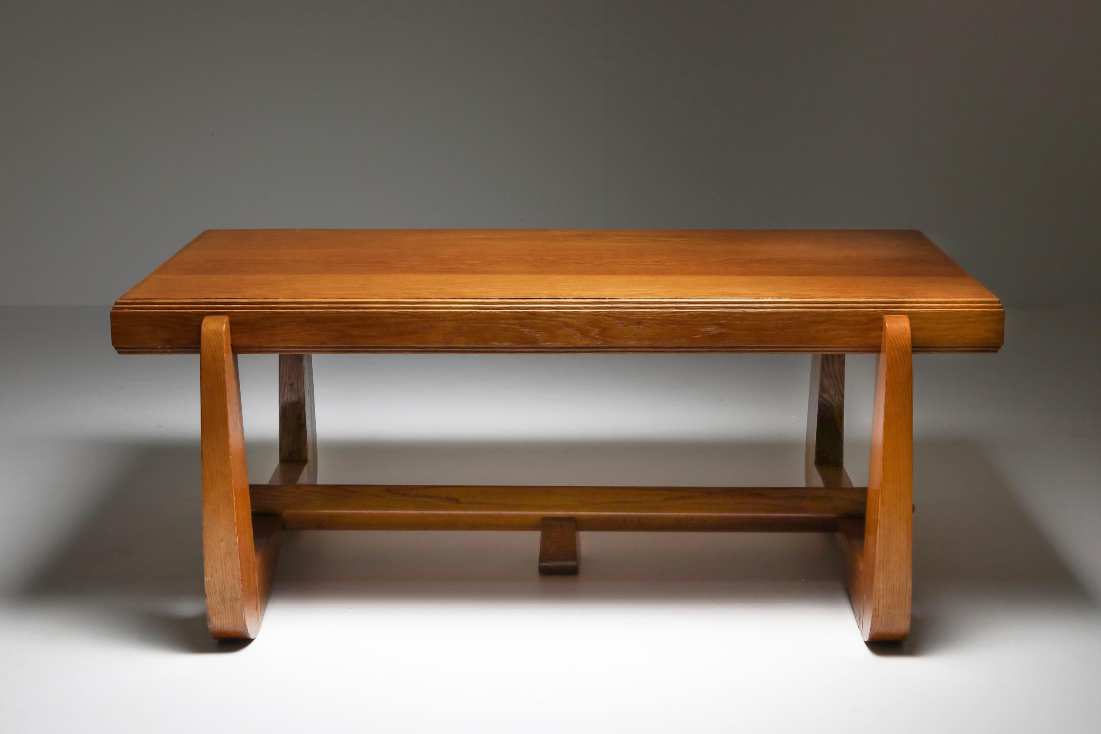 Art deco oak expressive table, a masterpiece of design by the iconic Amsterdam School movement from the 1930s. This exuberant and sculptural dining table draws its creative essence from the artistic vision of Dutch architects like Michel de Klerk