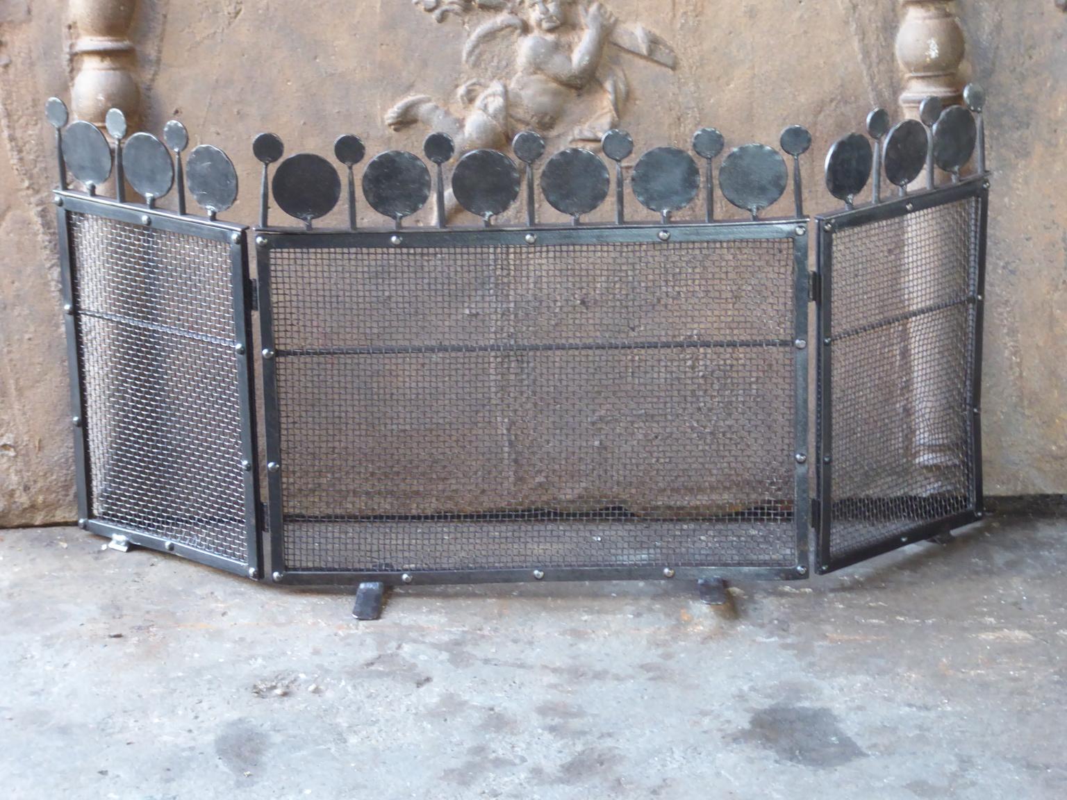 Dutch three-panel Art Deco fireplace screen made of wrought iron and iron mesh.

The height including the iron ball decorations is 15.4 inches.







