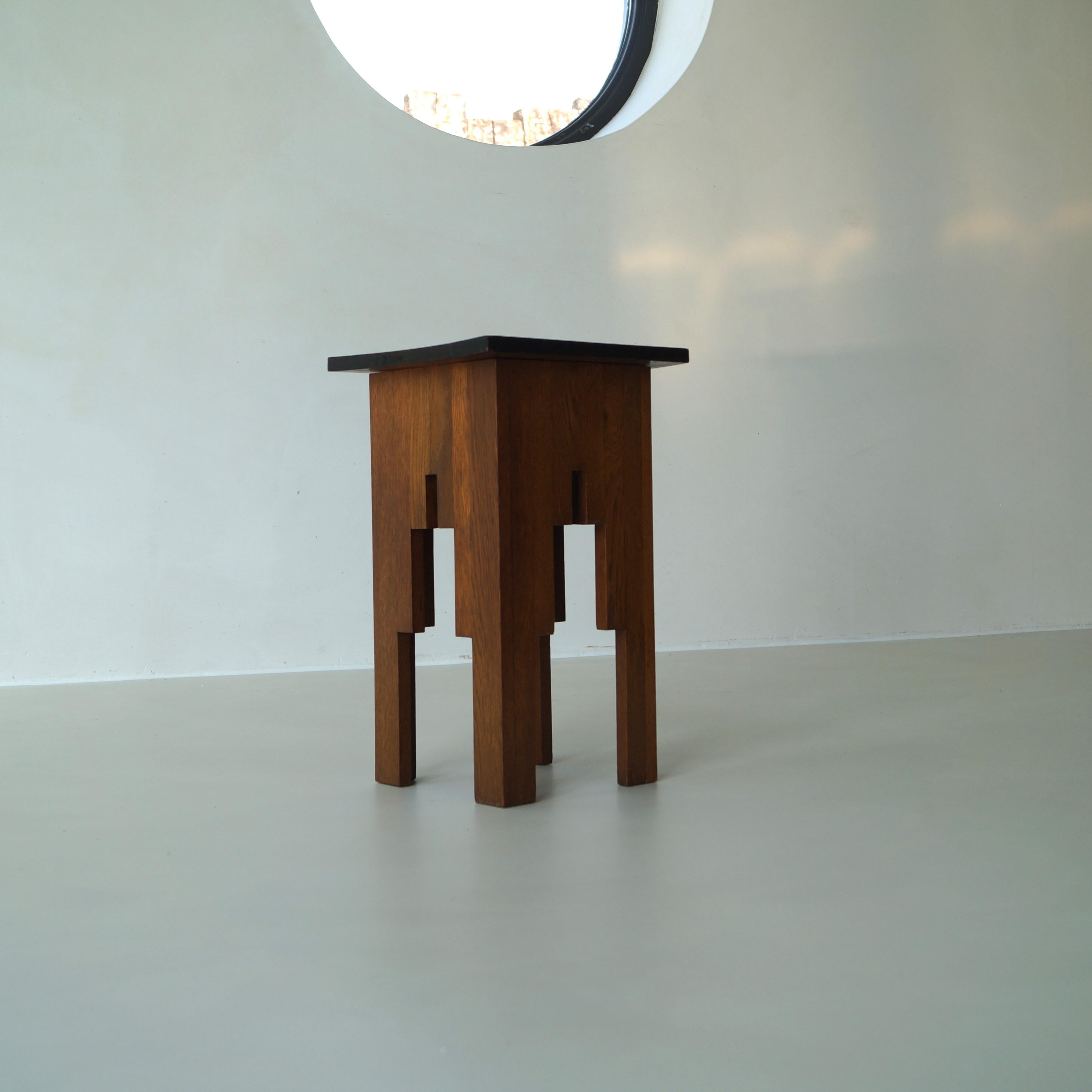 A Dutch Art Deco small side table, 1920s, in solid oak. It has a very decorative design with clean straight lines, which gives it a modernist appearance. Very suitable as an accent piece. Can also be used to display a statue or vase on.
The style is