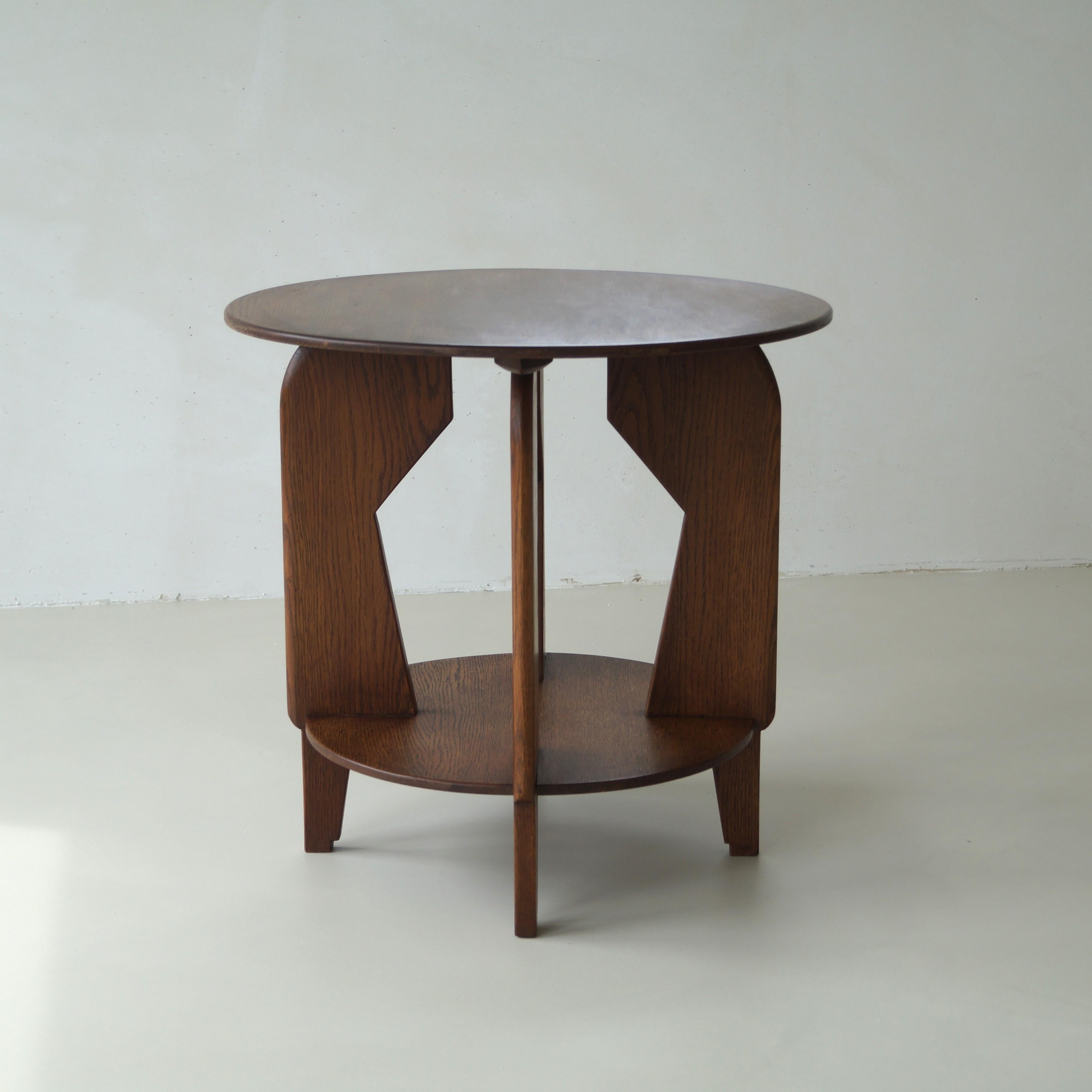 Dutch Art Deco occasional table or side table, late 1920s to early 1930s, in solid oak with modernist lines.  It is quite an unusual and stylish design with a modernist twist.

The style is more The Hague School but has some characteristics of