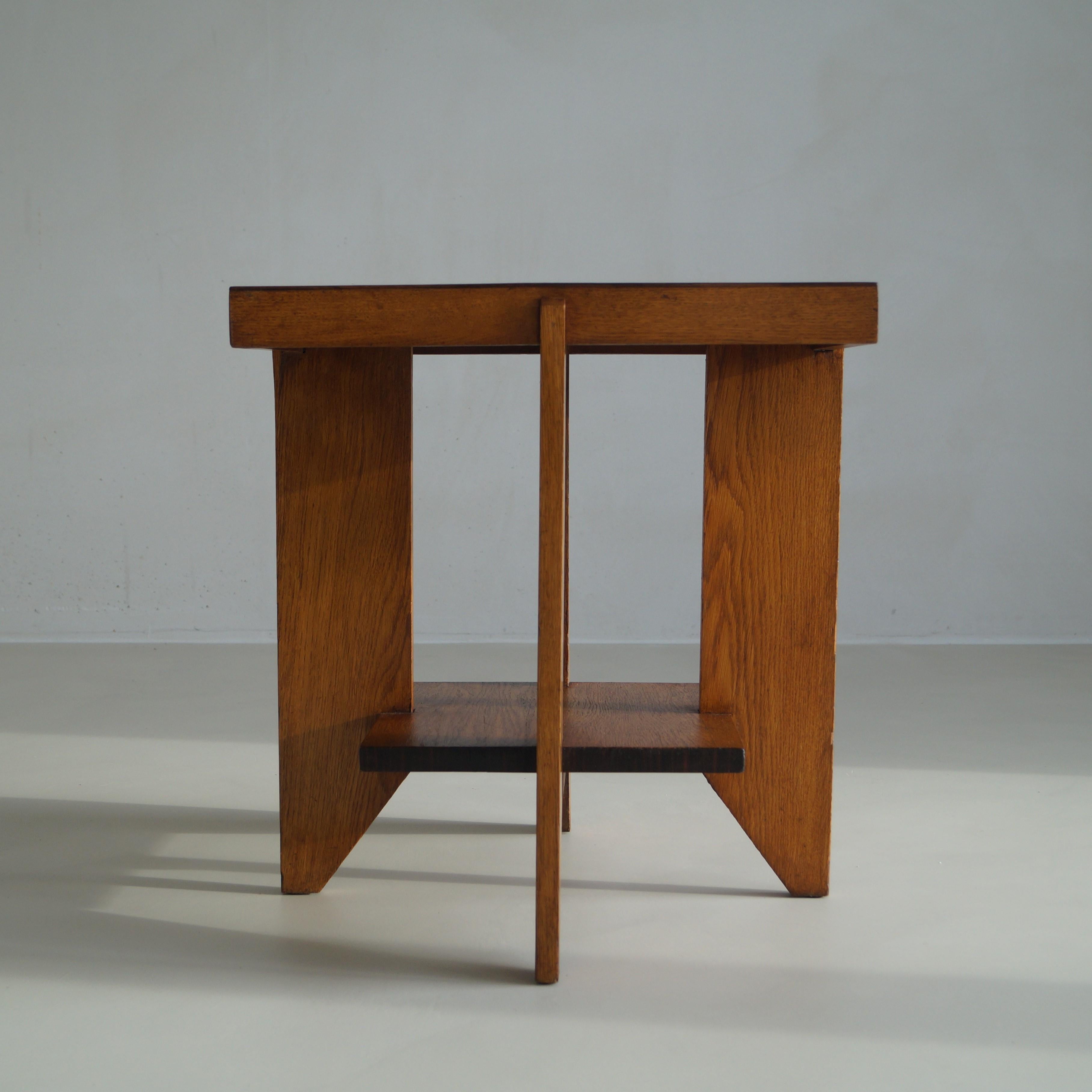 An occasional table or coffee table in oak and macassar ebony, 1920s. The modernist design with the pointed legs is very similar to the designs by Hendrik Wouda - hence attribiuted to. There aren't other known Dutch designers that used these same