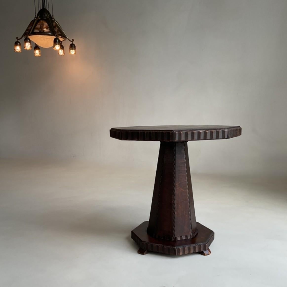 A rare, sculptural and richly decorated side table from the Amsterdam School period, dating to the 1920s.
Its design showcases the expressive, architectural qualities that define Dutch Art Deco Amsterdam School furniture. 
The piece is hand made and
