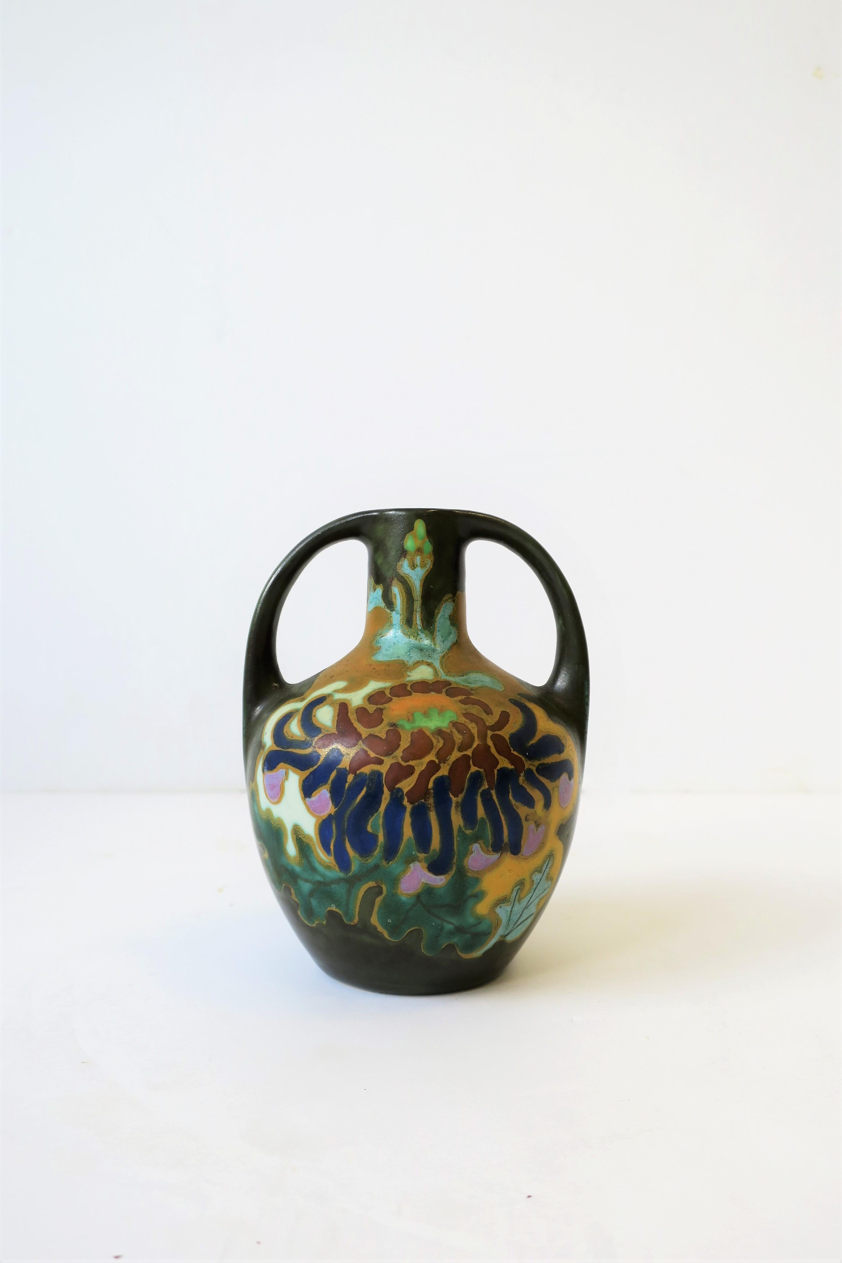 A beautiful small Art Nouveau Amphora matte pottery vase with colorful floral hand-painted design, from Holland. Piece is marked, signed, and numbered on bottom as show in image #7. 

Piece measures: 4