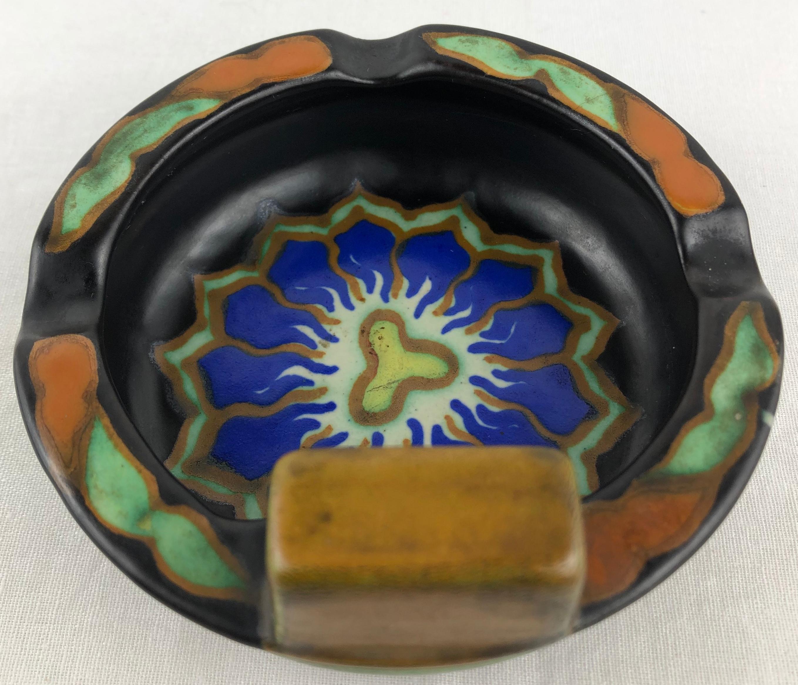 A beautiful Art Nouveau Gouda pottery ashtray.
Wonderfully colorful floral hand painted design, from Holland.
This well made decorative object can also be used as a key holder/vide poche.

Signed Dalia Konin Klyk, Coedewaalem, Gouda, Holland and