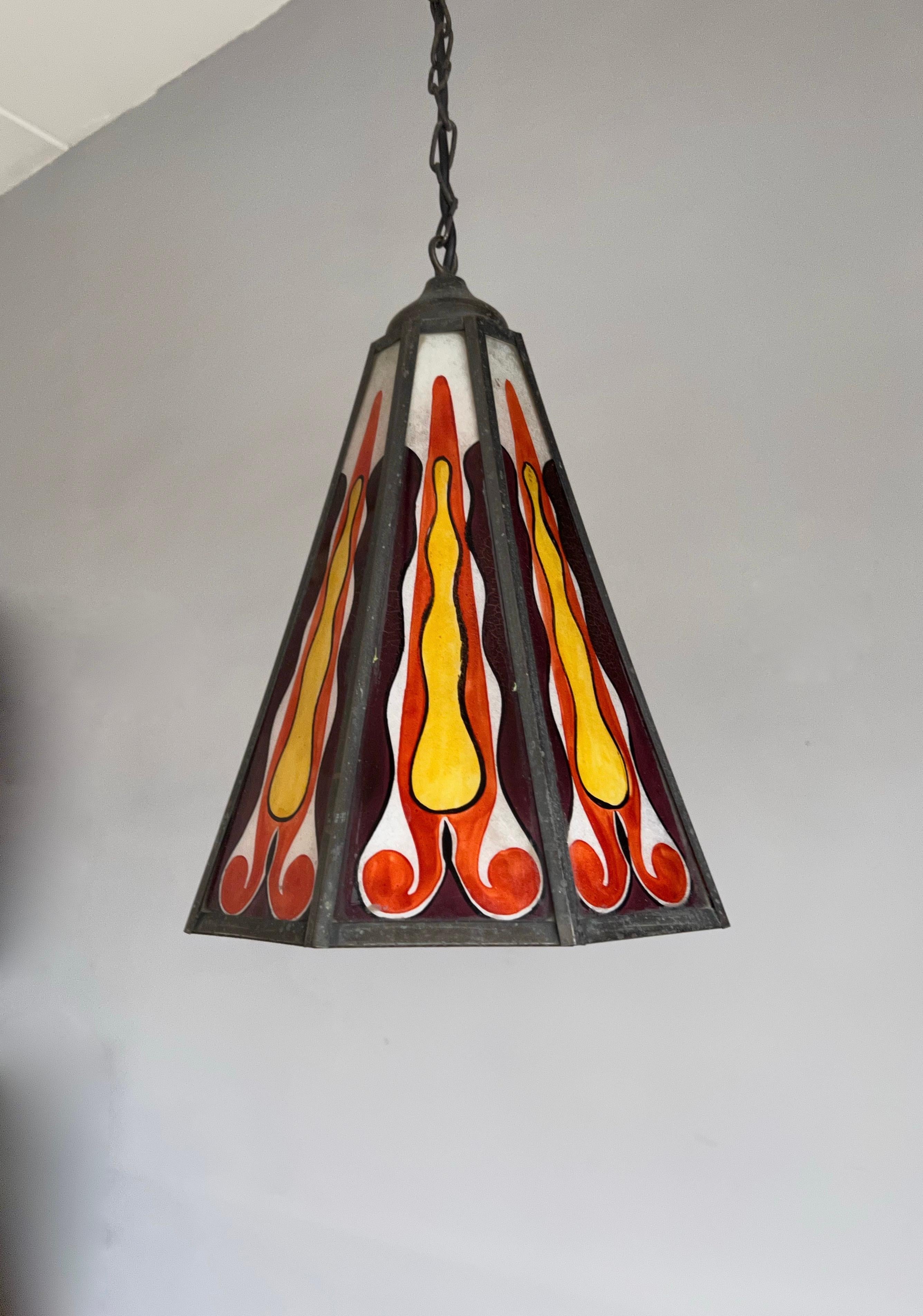 Another colorful and stylish light fixture from the early 1900's.

This rare and highly stylish lantern was made in early 1900s Amsterdam and the colors of the fire painted opaline glass combined with the marvellous patina of the octagonal brass