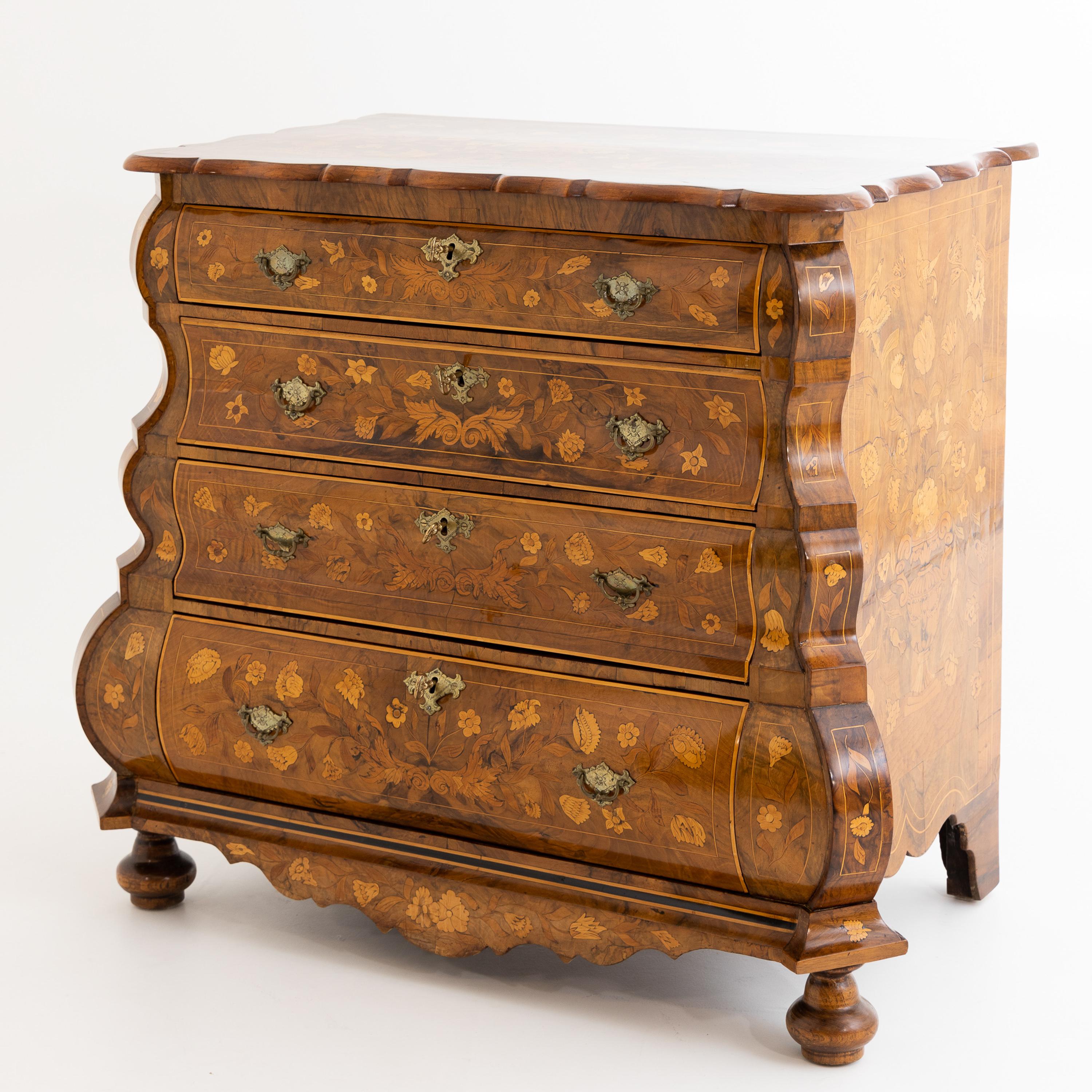 Dutch Baroque chest of drawers with four drawers on baluster feet at the front and bracketed feet at the back. The body is inlaid on all sides with floral marquetry. The top panel, corners and frame are typically curved. The chest of drawers has