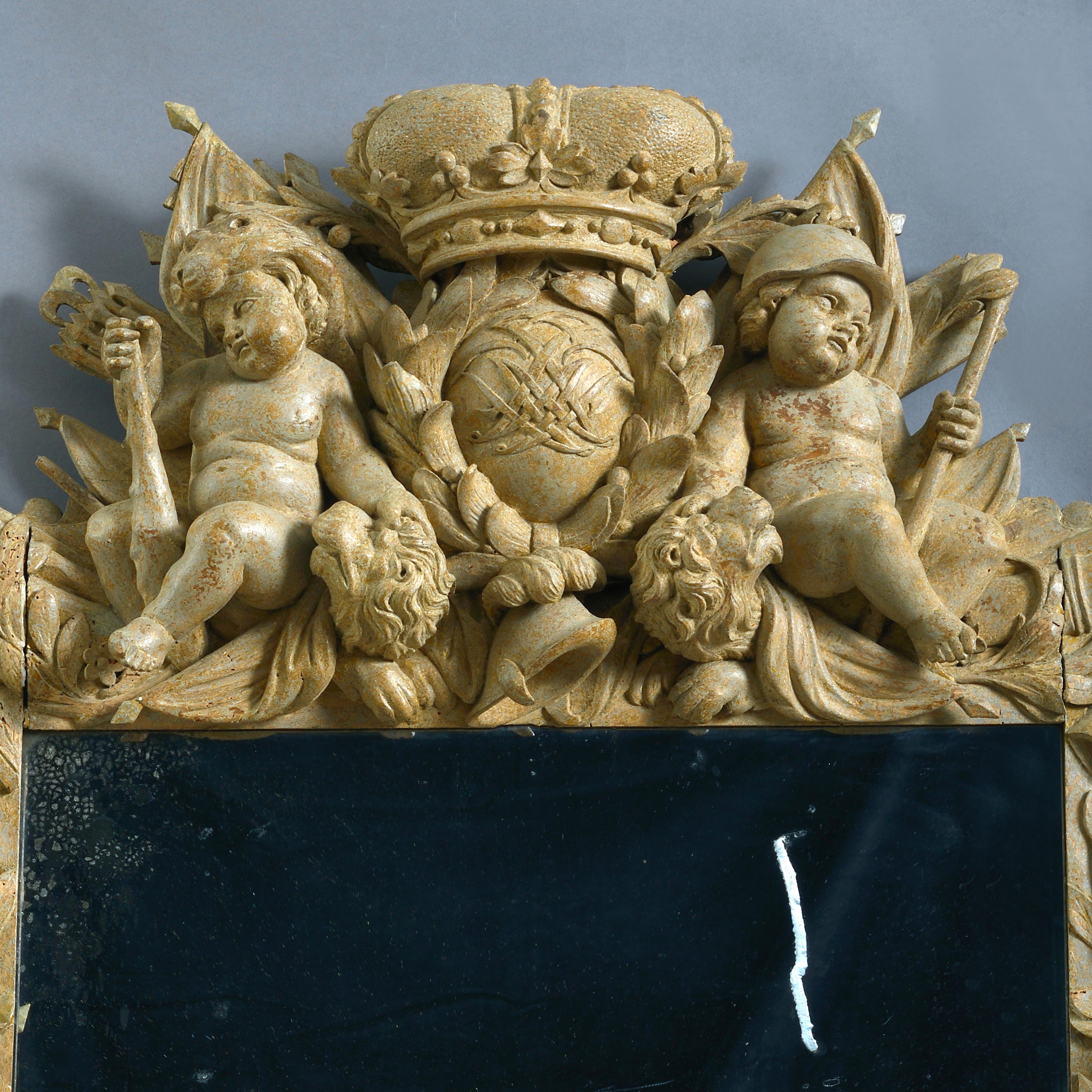 AN IMPORTANT DUTCH BAROQUE STONE-PAINTED CARVED LIMEWOOD MIRROR, DATED 1711.
With later plate. The frame carved with putti and trophies of arms. The apron with putti bearing laurels framing the sun rising above the sea and the date 1711. The