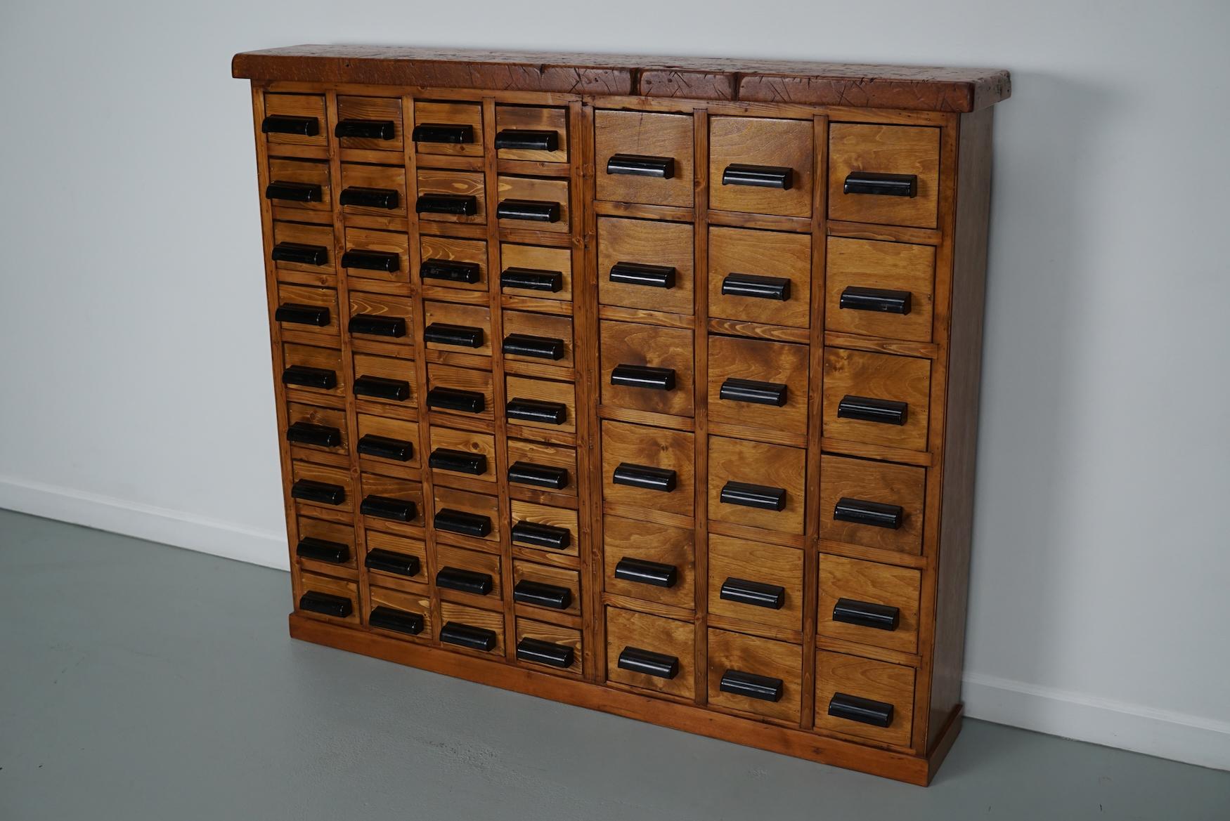 This workshop cabinet was made from pine / beech ply in the Netherlands circa 1950s and it was used in a workshop for dentist equipment. It features many drawers with nice bakelite handles. The interior dimensions of the drawers are: DWH 13 x 9 x