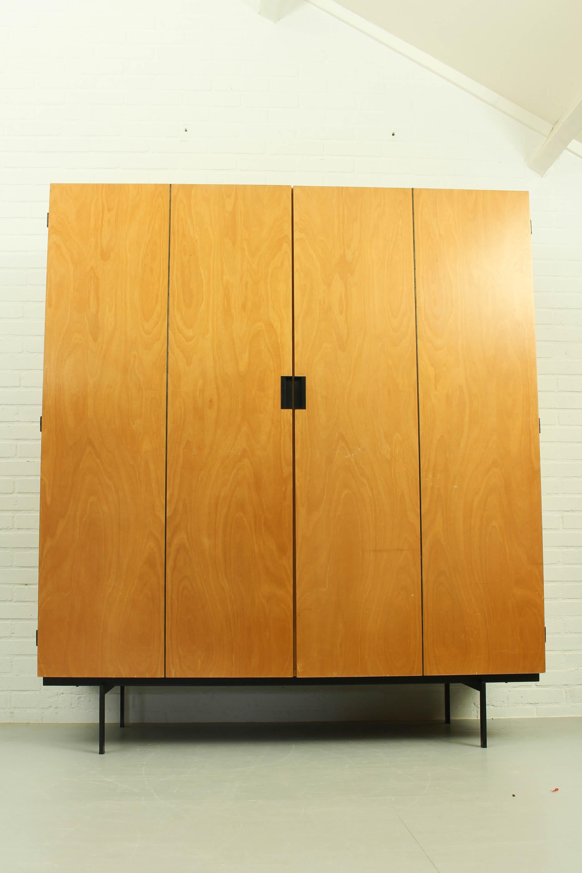 Rare birch edition wardrobe KB14 Cees Braakman Pastoe Japanese series 60s. It has two doors in teak with an additional folding mechanism, revealing four storage spaces. Iconic square black metal handles make it a piece o the very recognizable