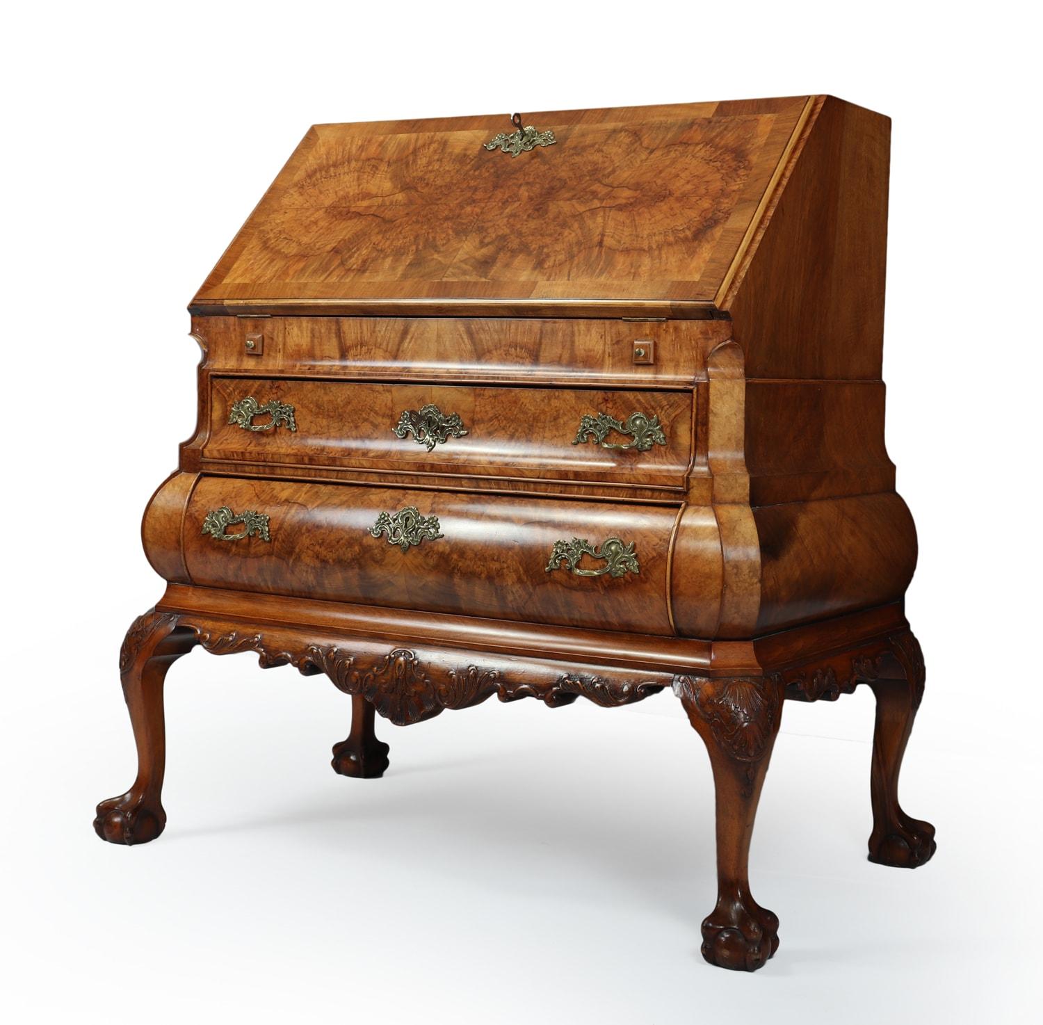 Dutch Bombe Bureau in walnut
A fine quality Dutch bombe Bureau produced in the first quarter of the twentieth century from solid walnut and oak and stunning burr and figured walnut veneers, the bureau opens to reveal a fully fitted stepped interior