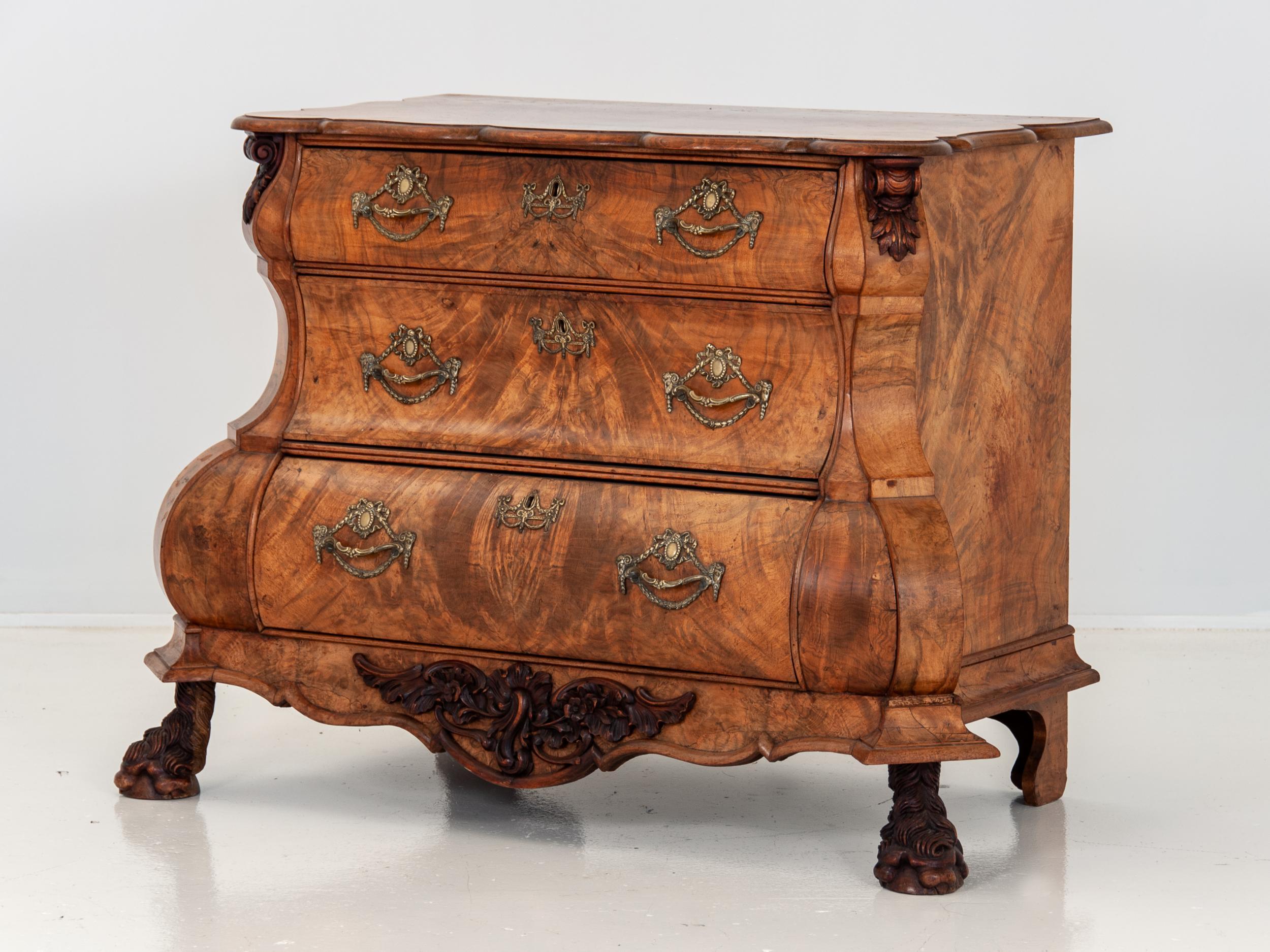 Stunning antique late 19th century Dutch bombe or dresser made in the Netherlands in the late 19th century. Sinuous serpentine silhouette in a beautiful book-matched veneer. Carved acanthus leaf details with exquisitely carved paw feet. Dresser is