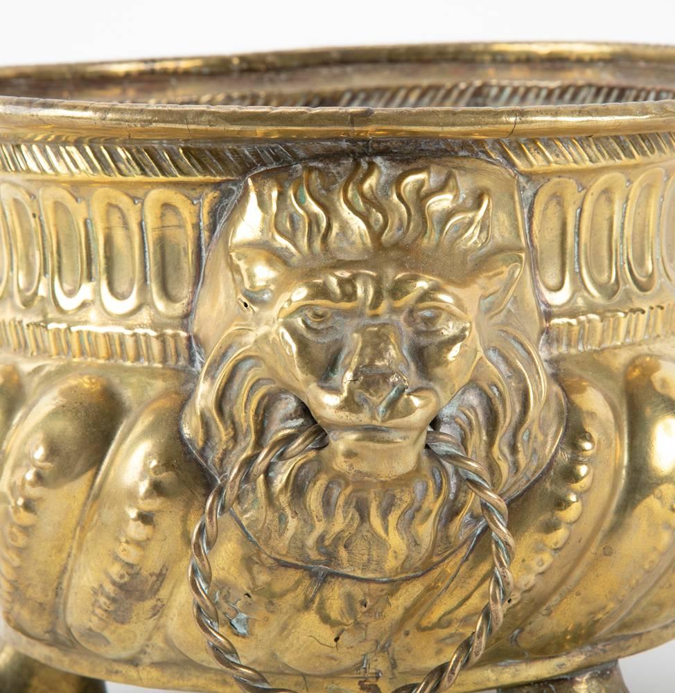 Repoussé Dutch Brass Cachepots with Lion Head Handles and Paw Feet, a Pair