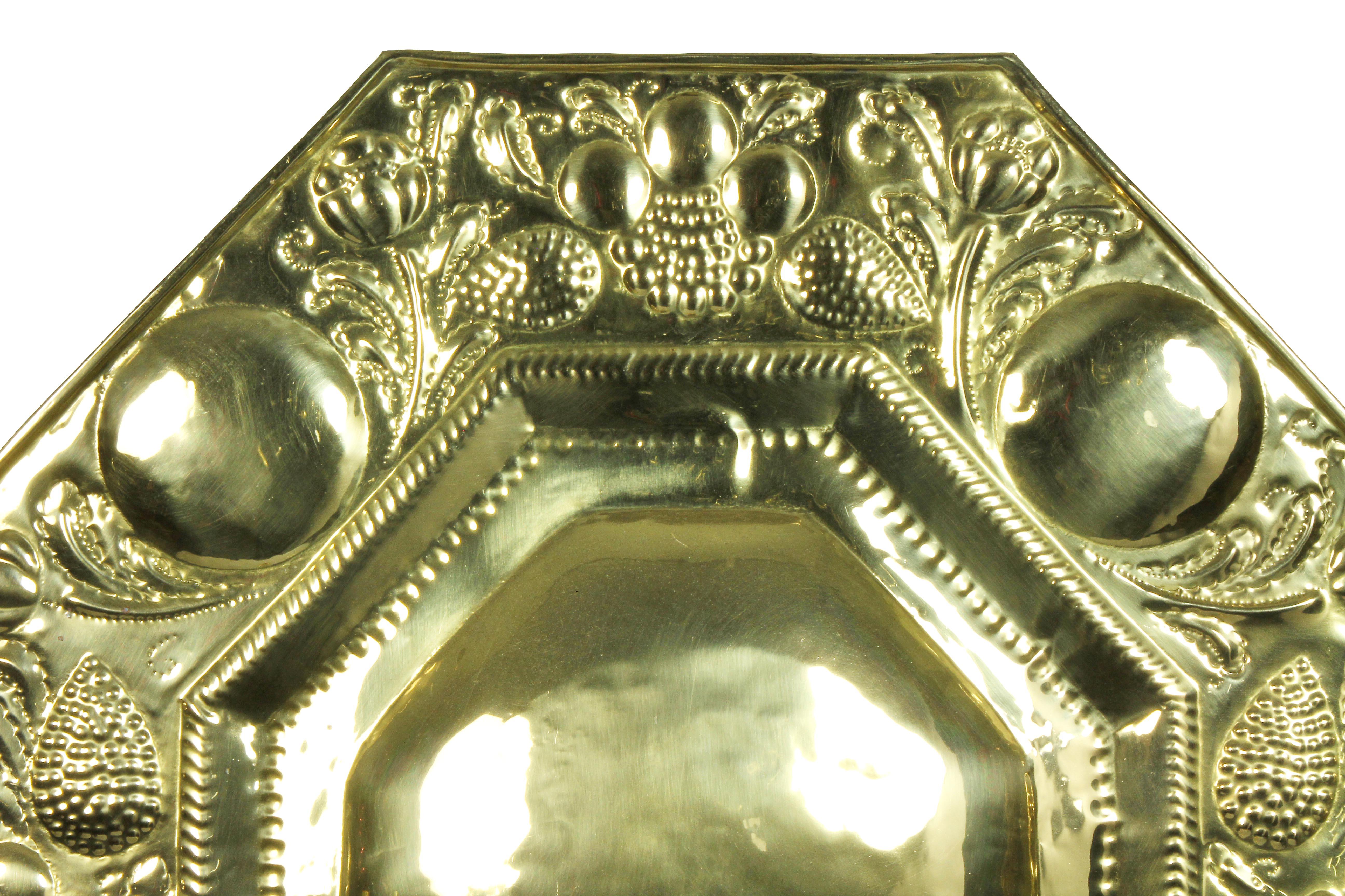 Decorative octagonal hammered brass single light sconce.