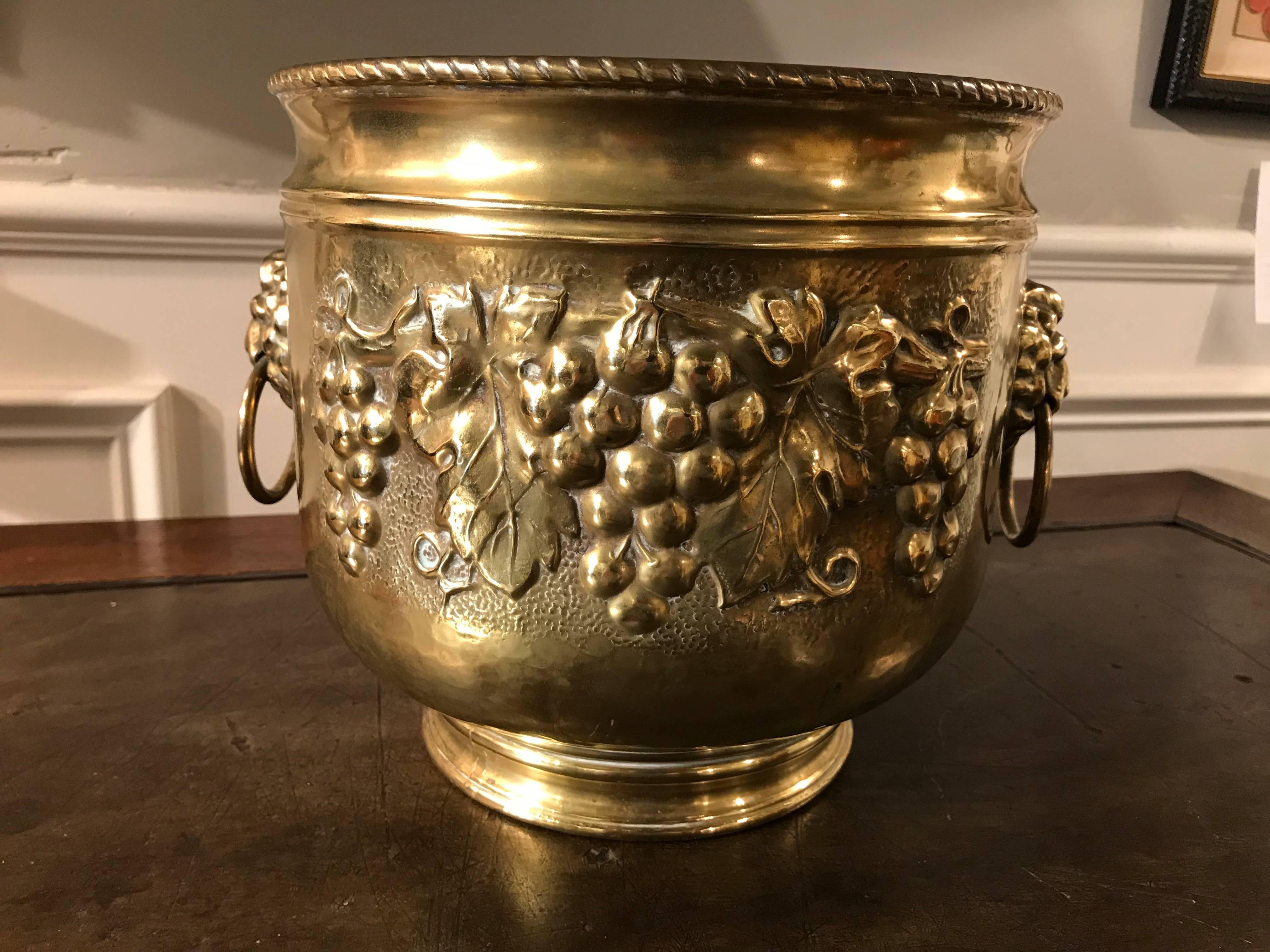 Dutch brass urn form wine cooler with grape vine decoration and lion head terminals with rings in their mouths as handles. This makes for a unique ice bucket, perfect for that summer rose wine!
Or a stunning jardinière for your favourite plant.
