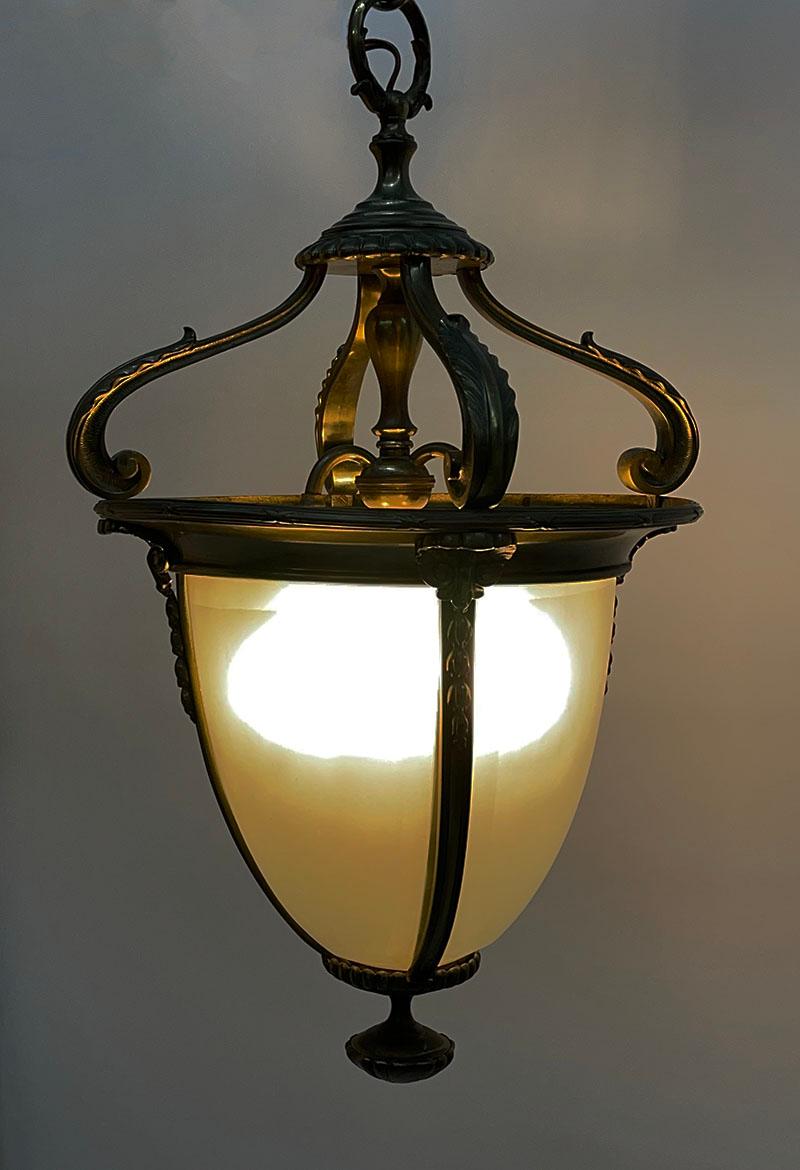 Dutch bronze hall lantern, circa 1900

A bronze hall lantern with shell and leaf pattern with round frosted and facet cut glass. 
In the inside of the lamp there is a 3 arm fixture for 3 light bulbs. 
The measurement is 65 cm high and 37 cm
