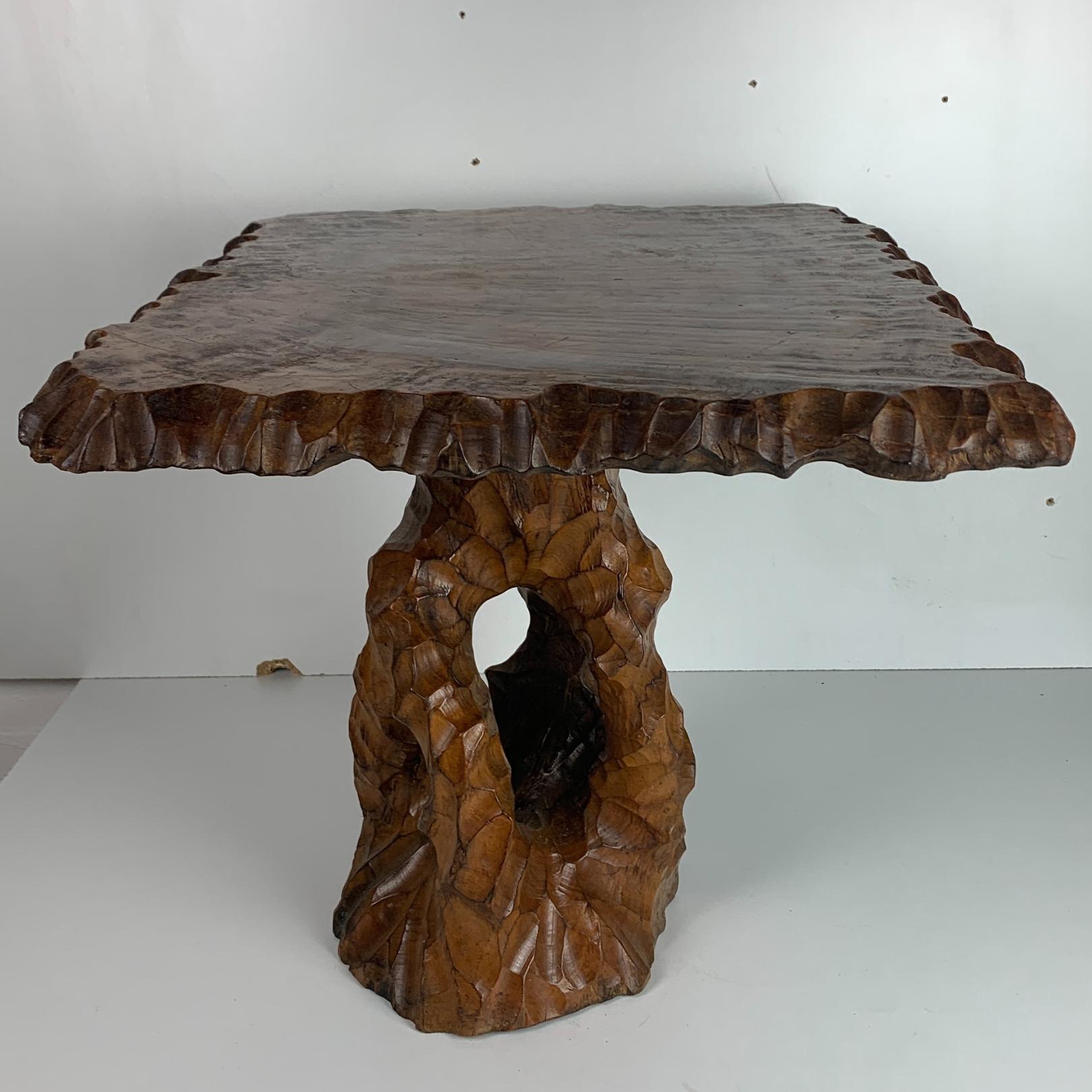 Gorgeous carved side table from The Netherlands. These asian revival tree trunk root side tables were popular during the 50s and 60s. Generally we tend to find the smaller stools or the plant stands but this table so this table therefore is fairly