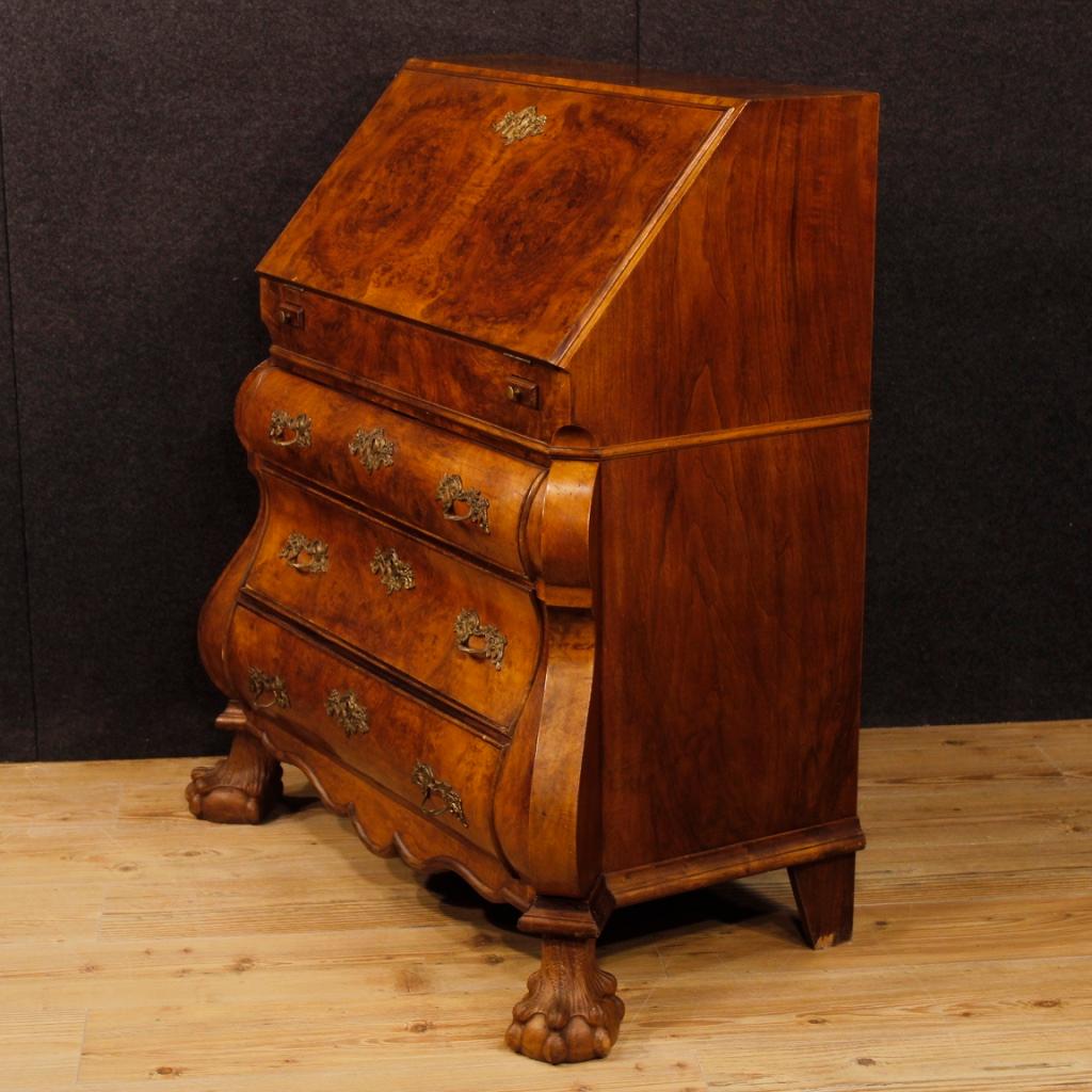 Dutch bureau from the mid-20th century. Furniture richly carved in walnut, burl and mahogany. Bureau with three external drawers of excellent capacity and service, desk top covered in fabric with different signs, to be replaced. It has six small